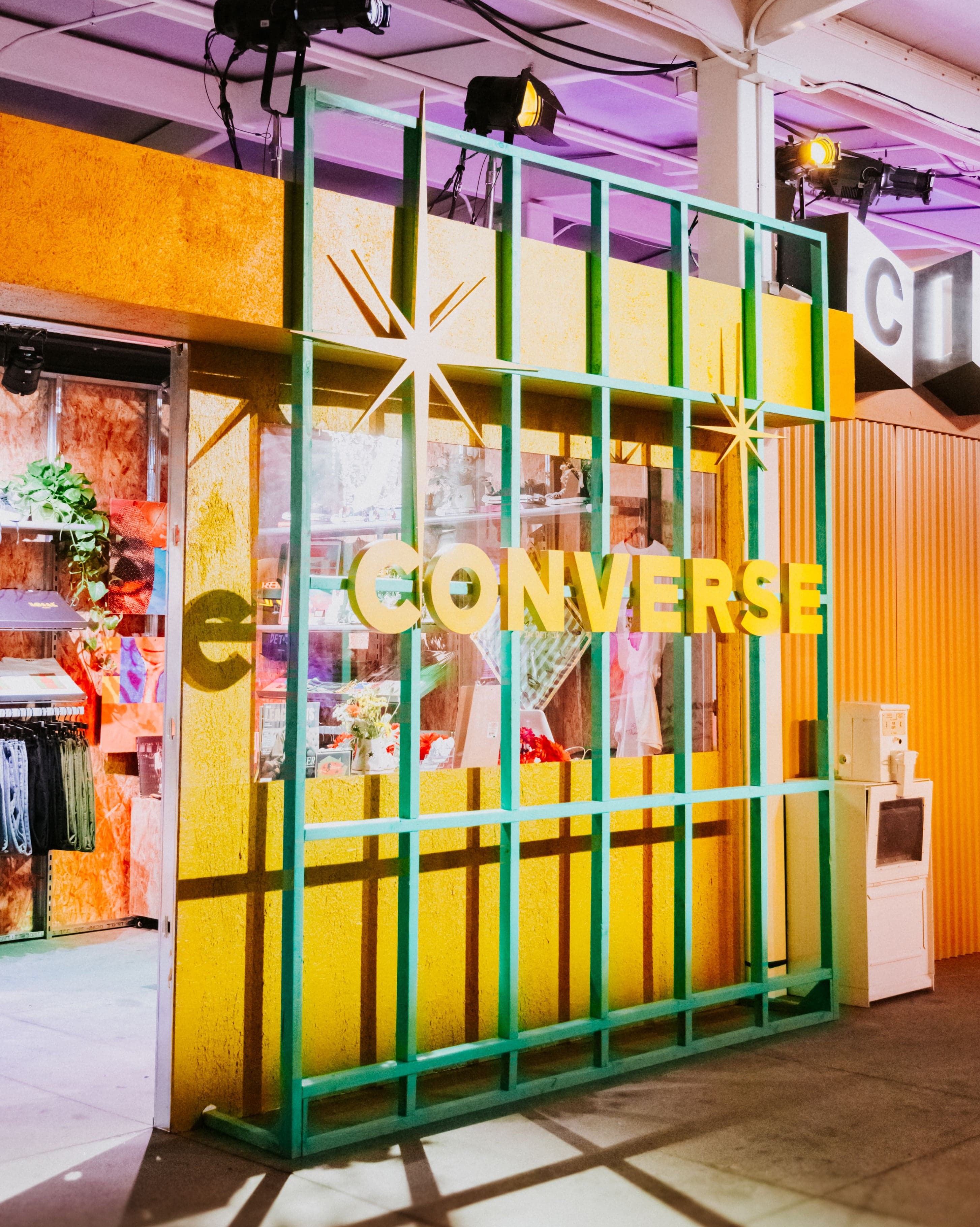 The Converse booth behind a green and yellow metal grid