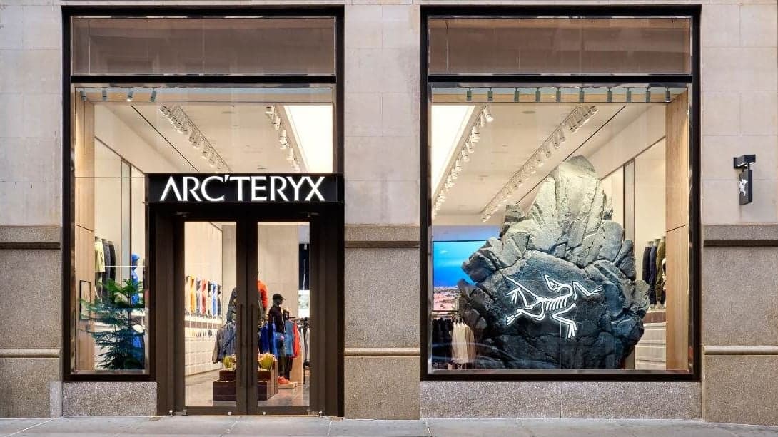 The Arc’teryx SoHo storefront, with a sculpted rock and the bird logo in the window