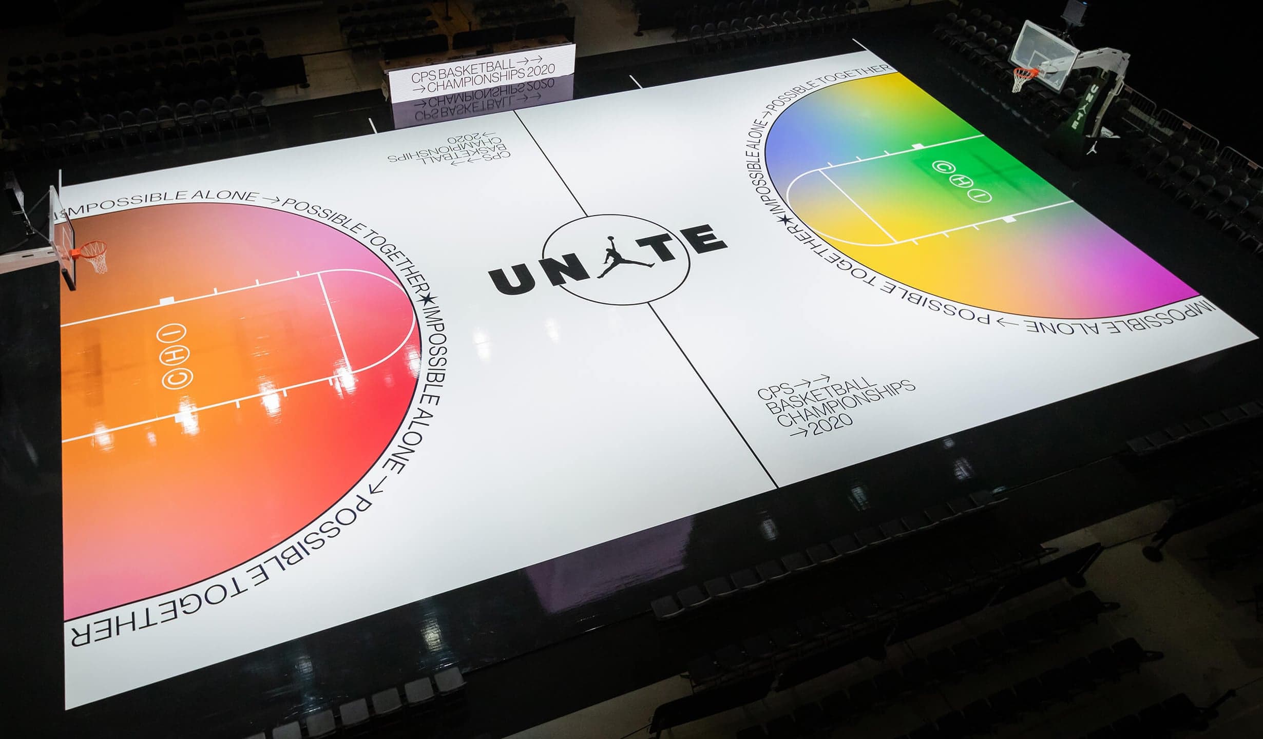 A white court with the UNITE logo and orange and rainbow gradient keys, seen from above
