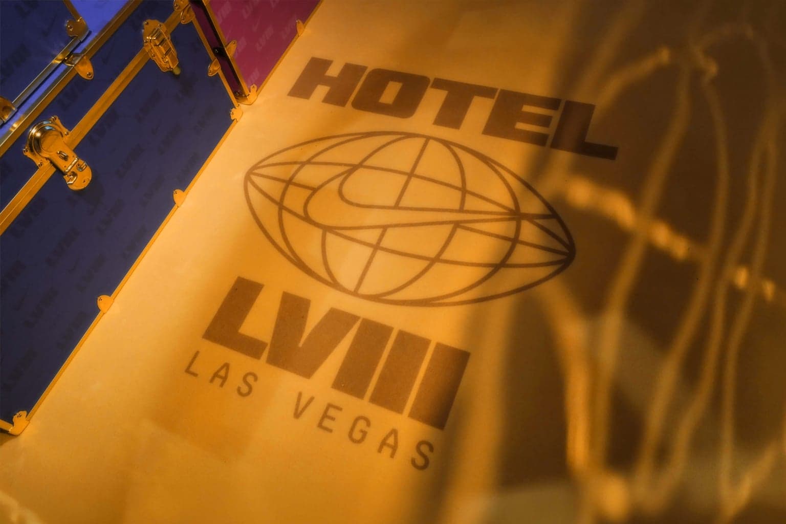 The Hotel LVIII Las Vegas logo printed in gold on a blue trunk