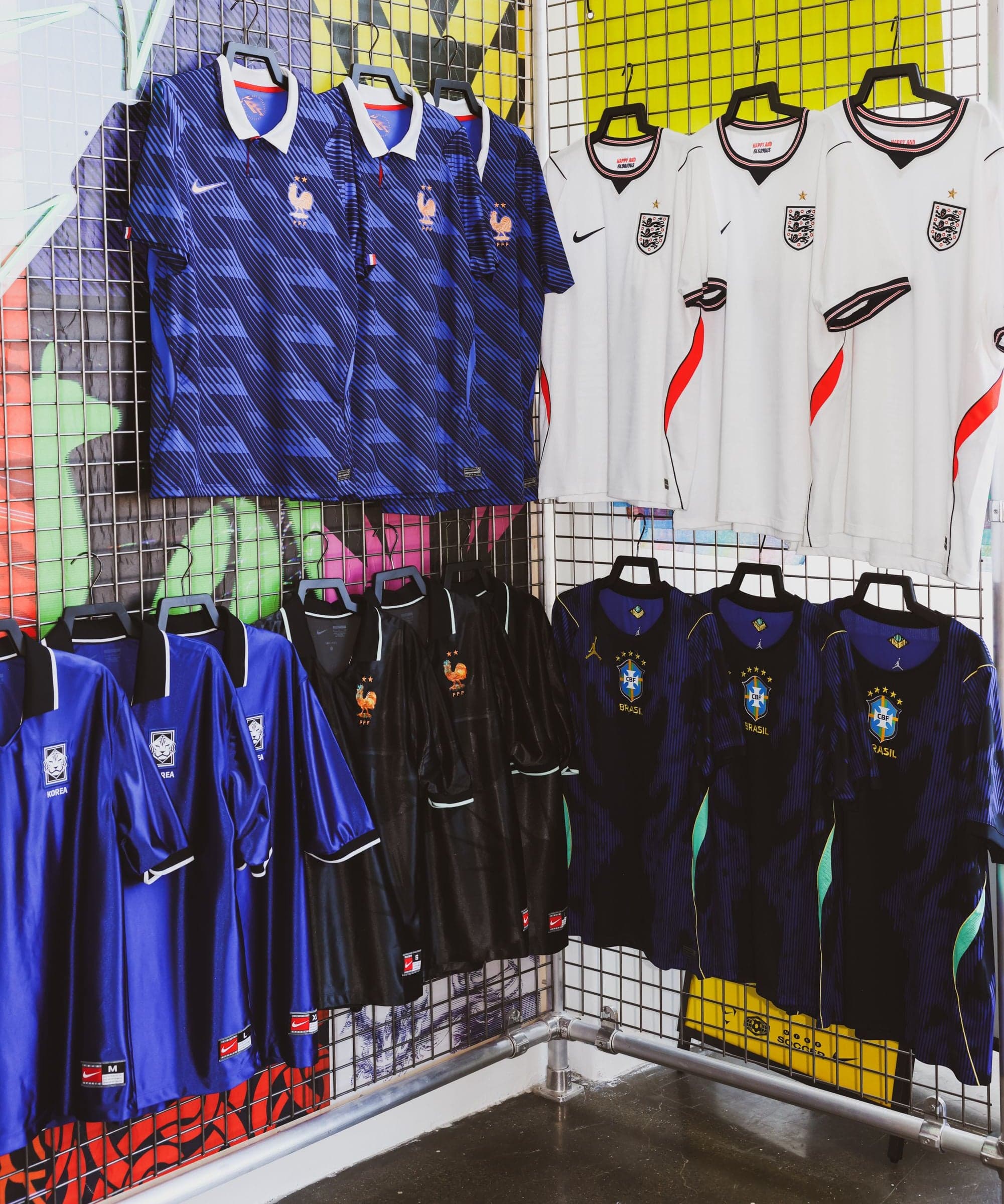 A rail of national team jerseys on a pegboard wall