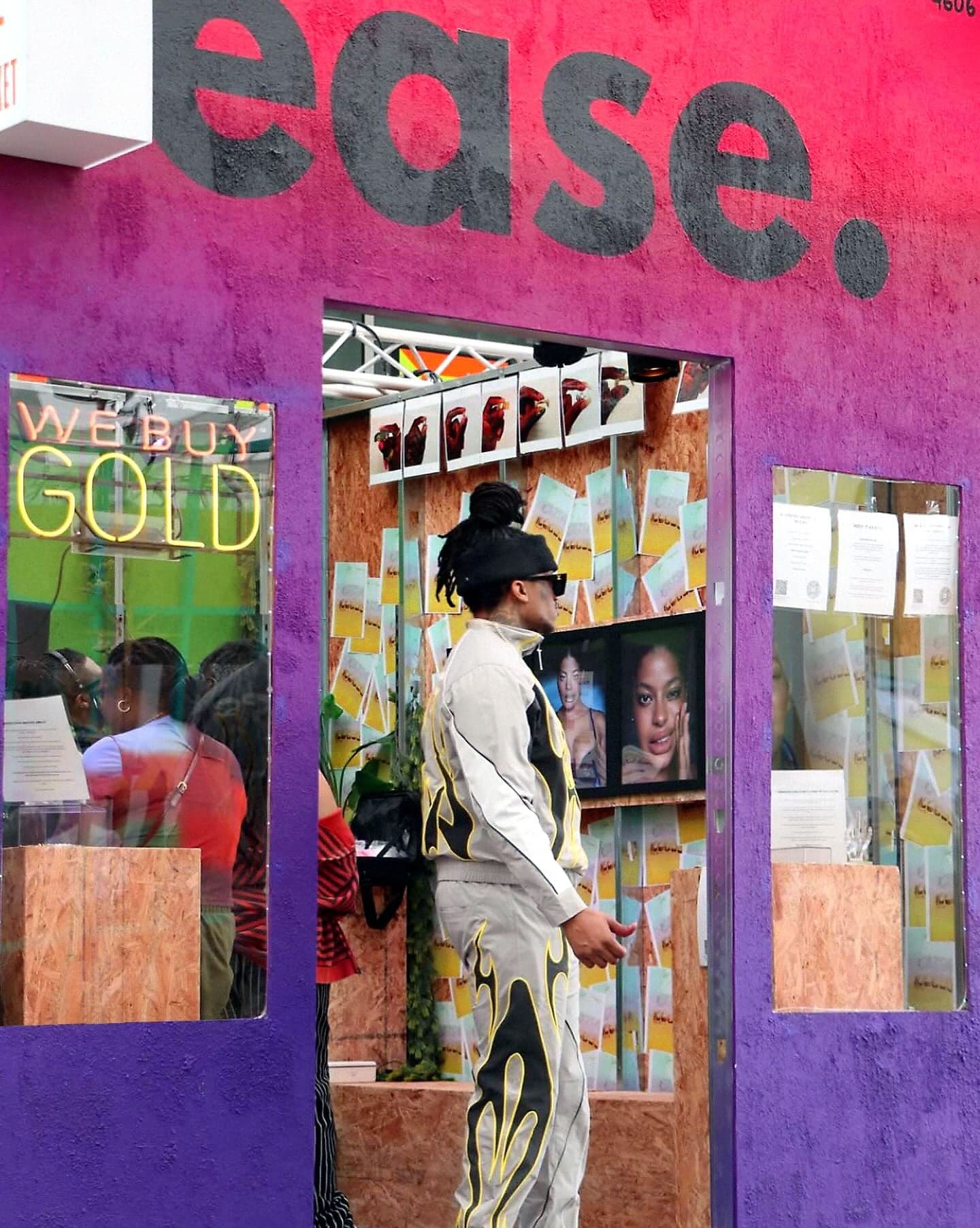 The purple “ease.” storefront with a guest in the doorway