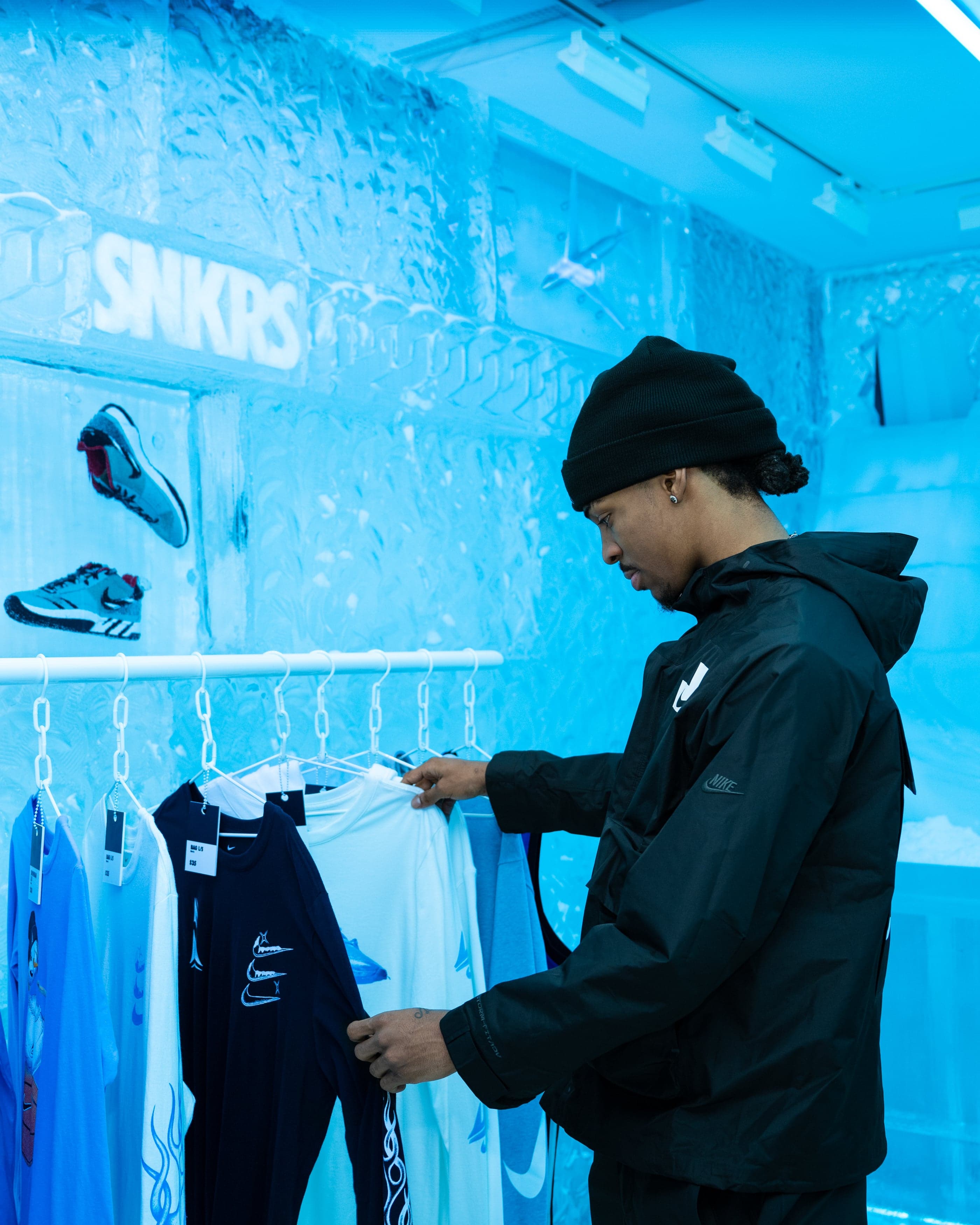 A shopper browsing jackets on the racks in the ice store