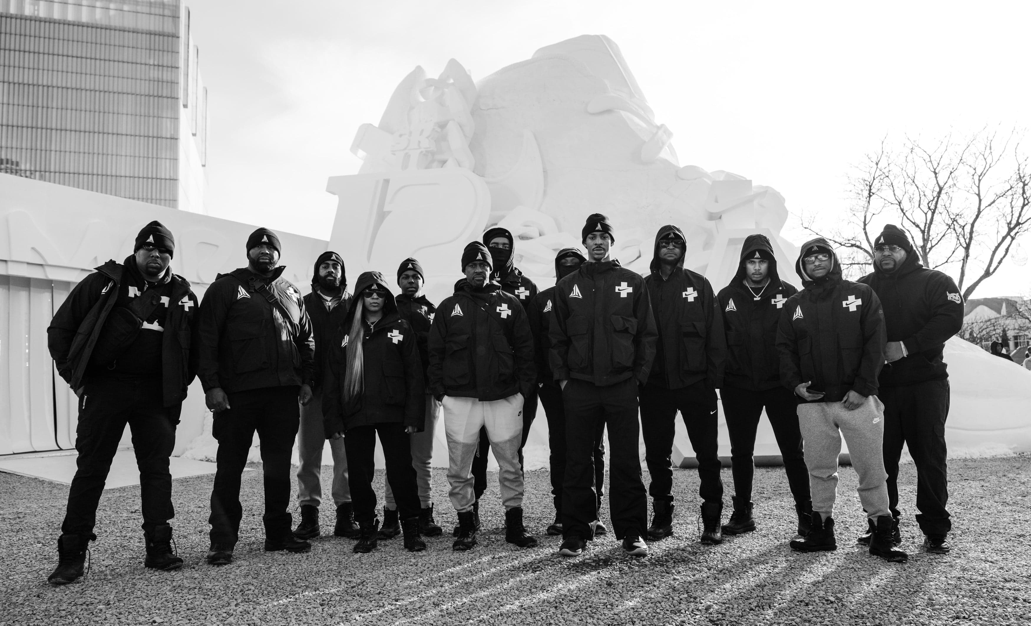 Black-and-white photo of the team in front of the snow sculpture