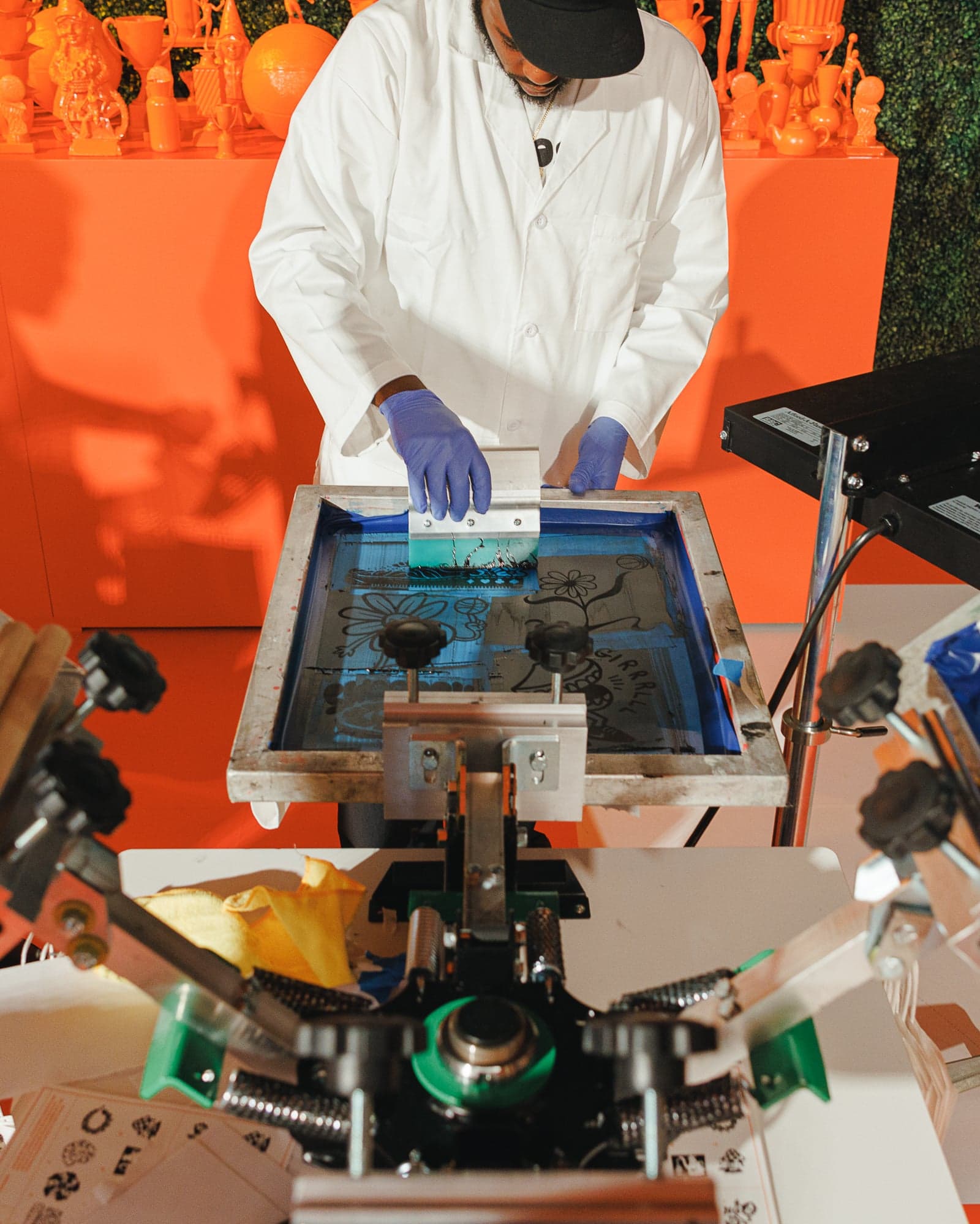 A staff member screen-printing a design