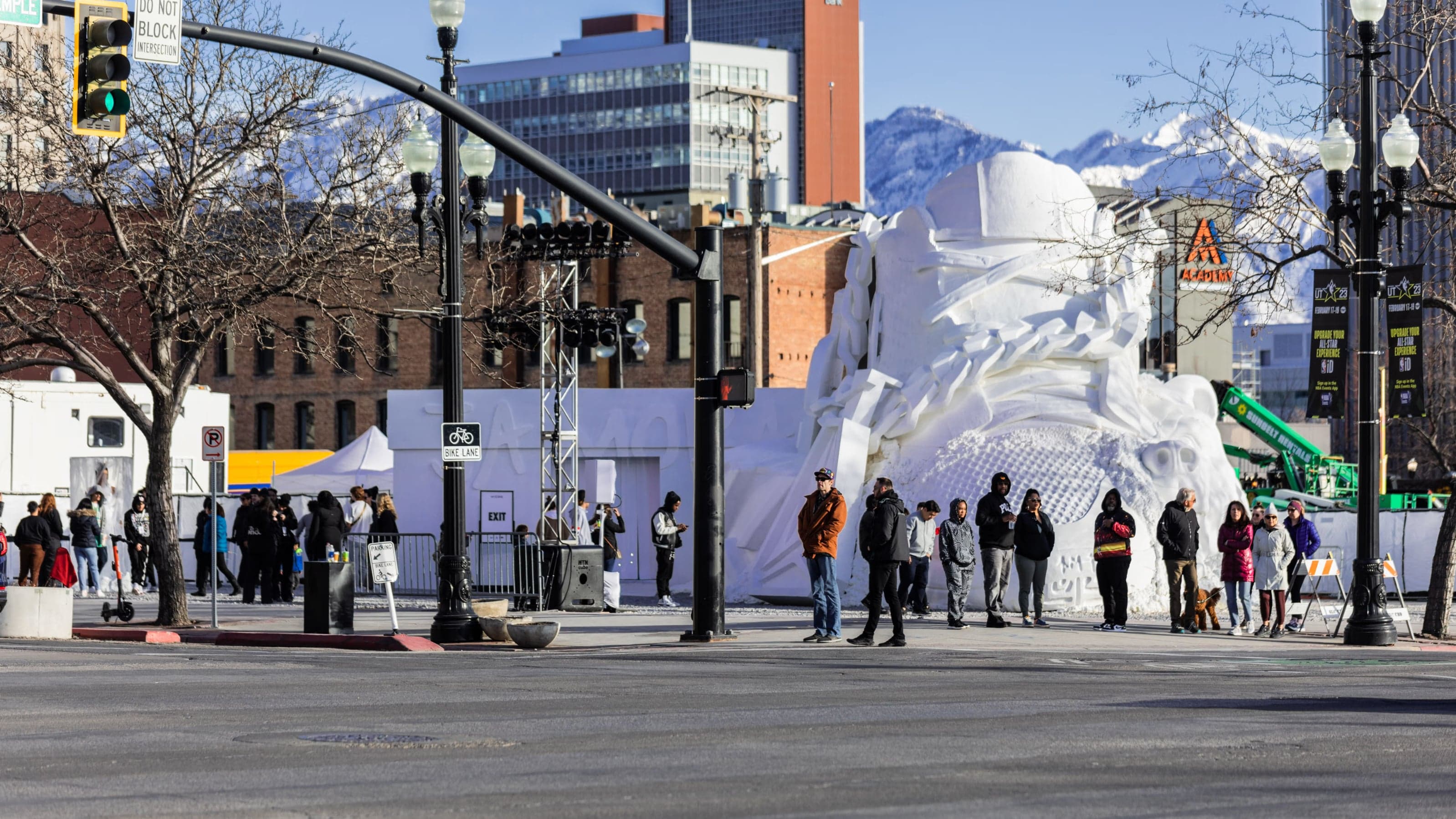 Visitors lining up on a Salt Lake City street beside the giant snow sculpture