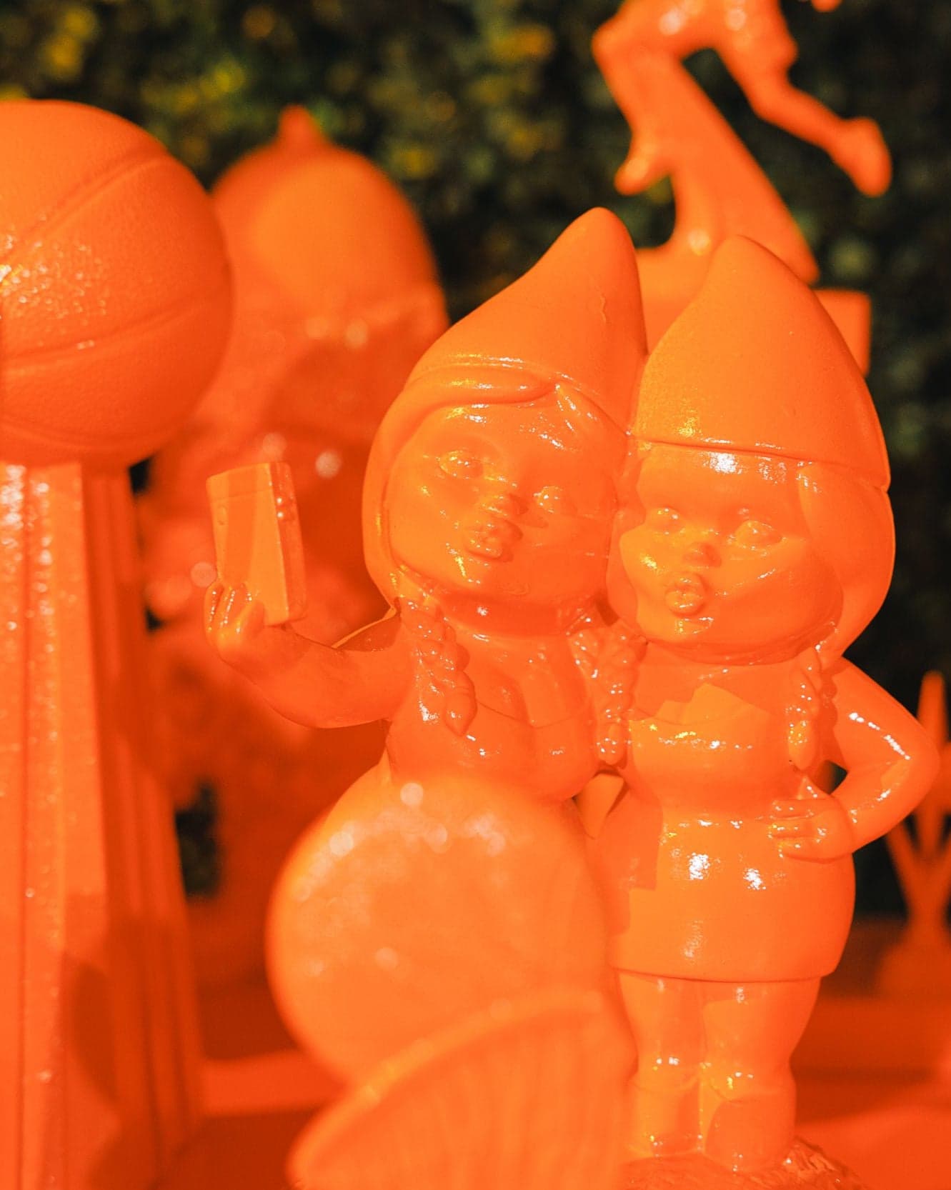 Orange figurines of a basketball and characters