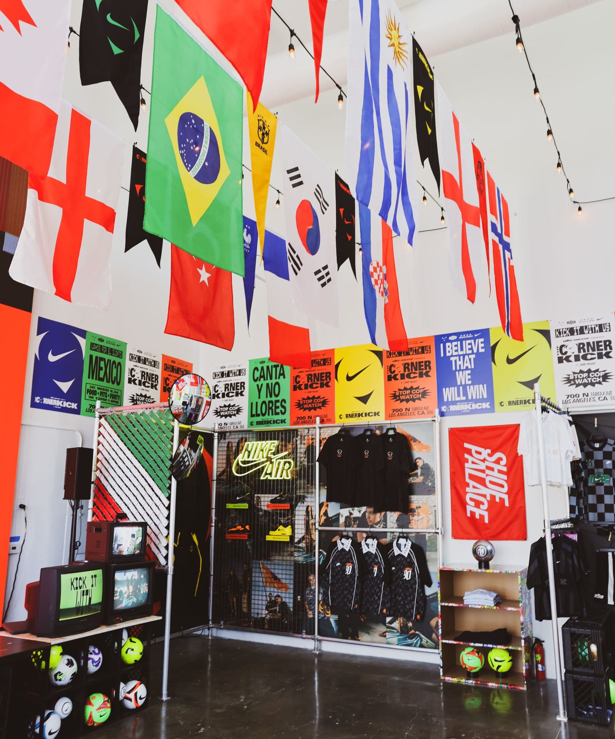 Flags of World Cup nations hanging from the ceiling above the merch area