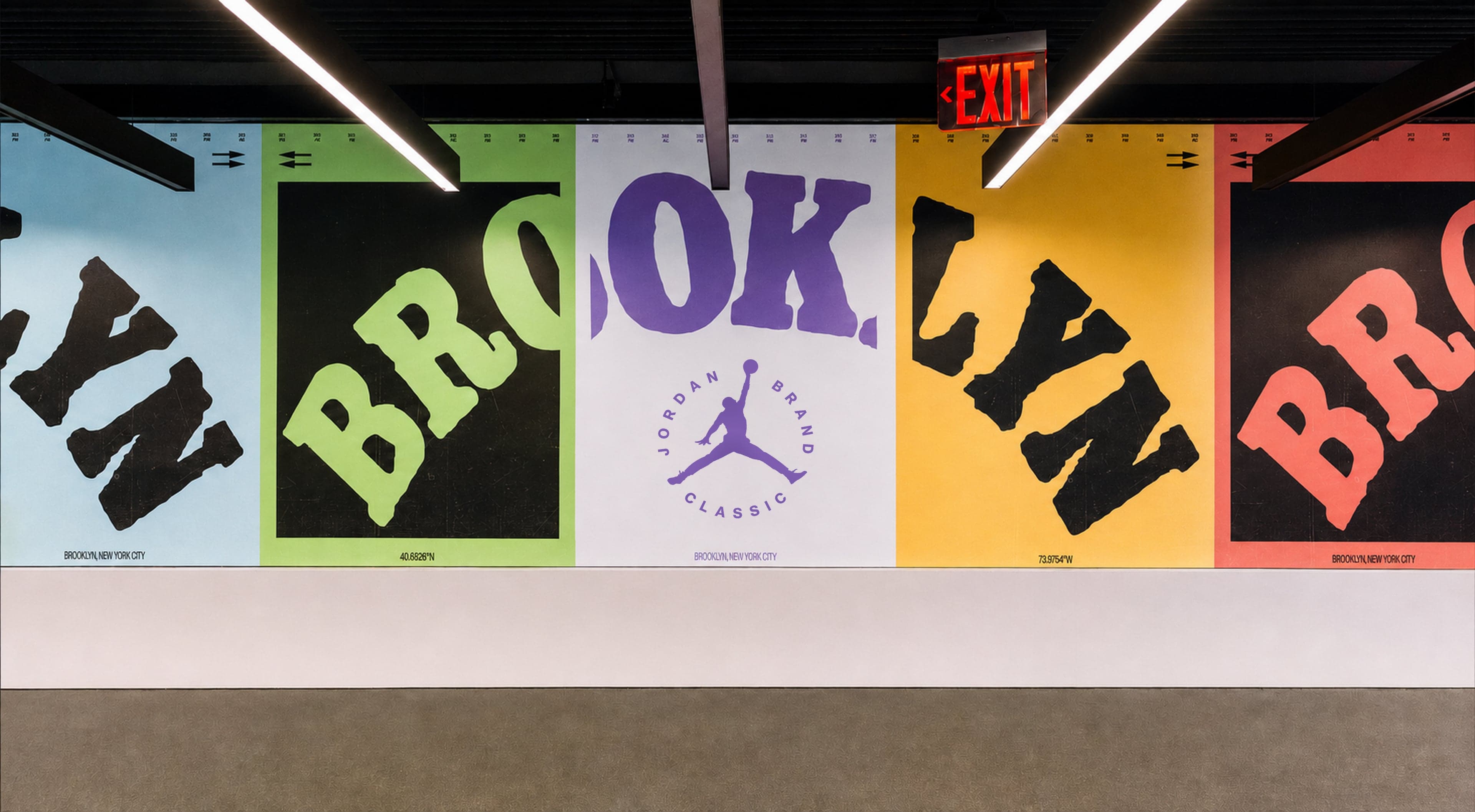 A row of colorful Brooklyn posters beside a Jordan Brand Classic poster along a gallery wall