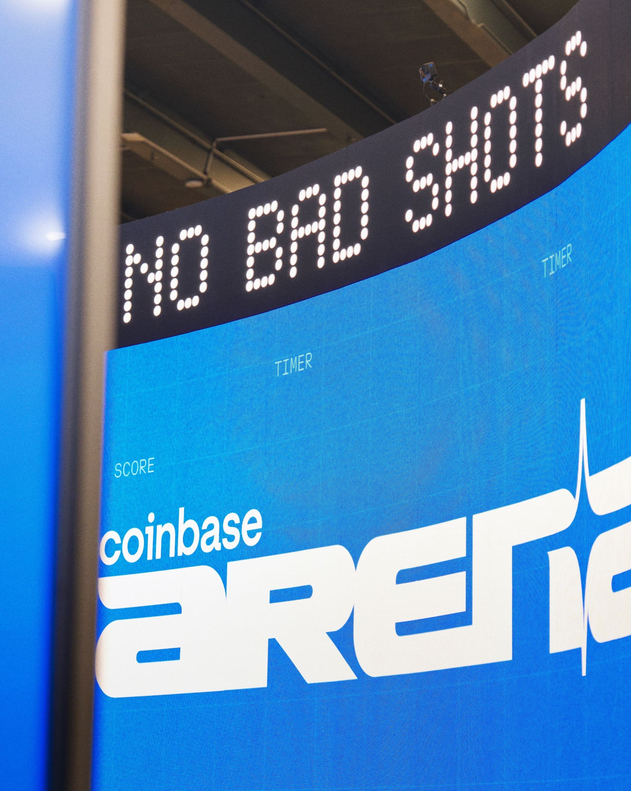 “No Bad Shots” scrolling on the LED ticker above a Coinbase Arena wall