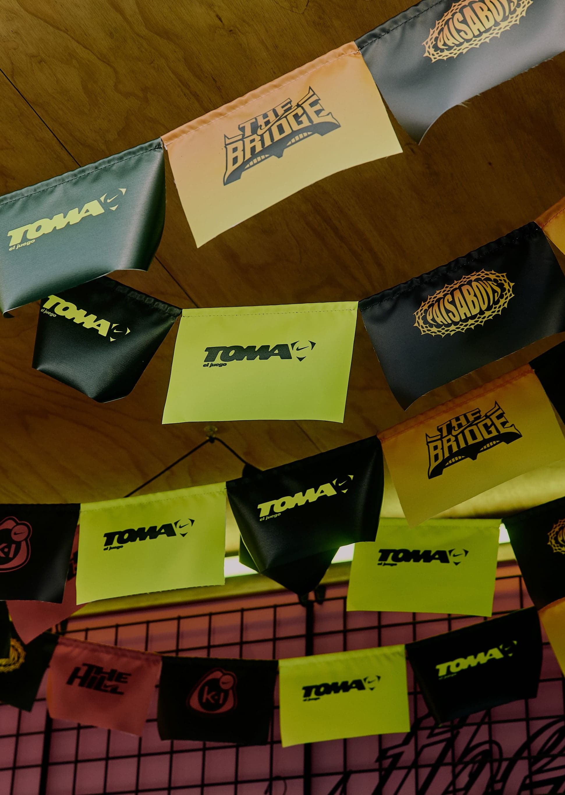 Papel picado-style TOMA banners strung across a ceiling
