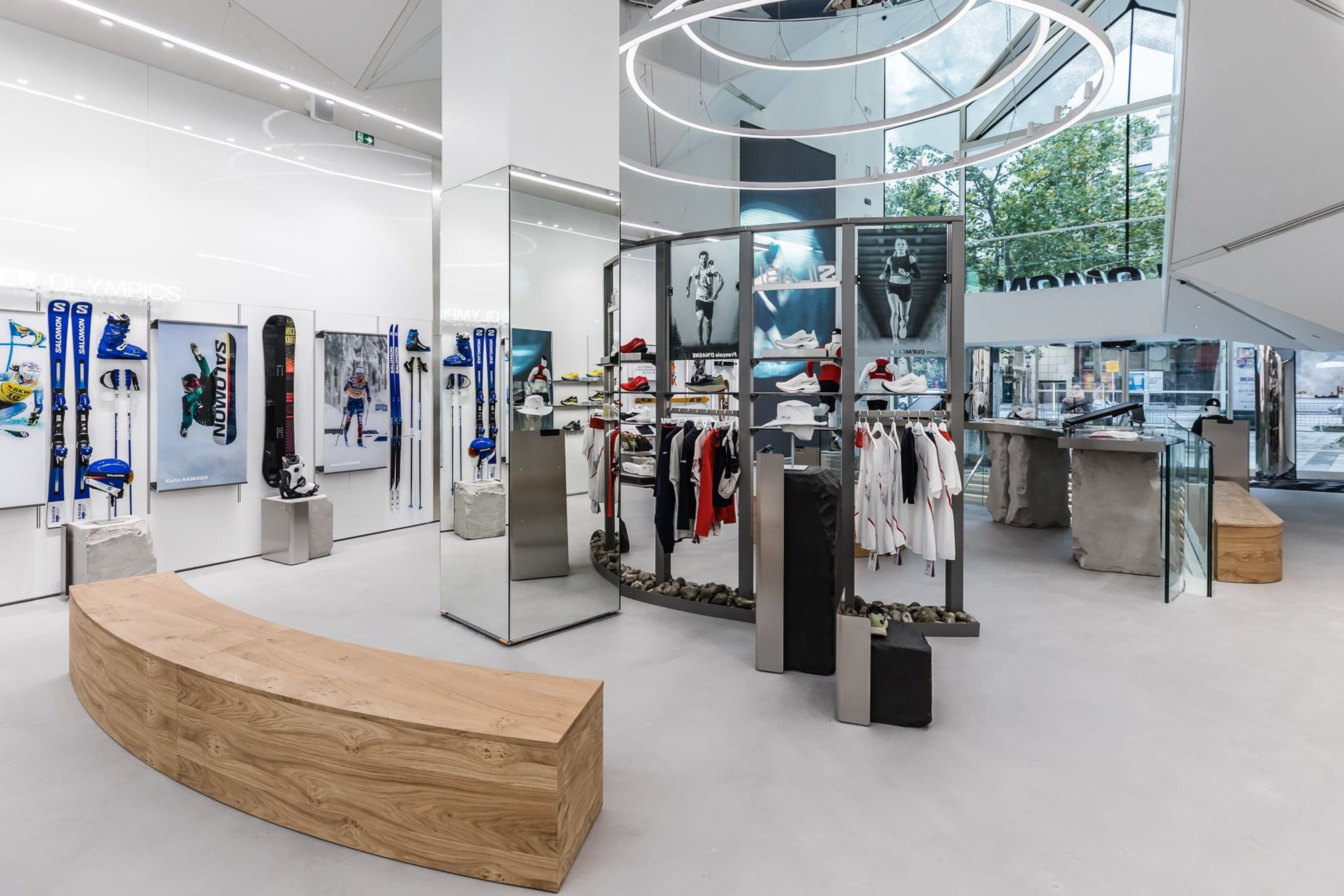 Ski and apparel displays around a curved wooden bench