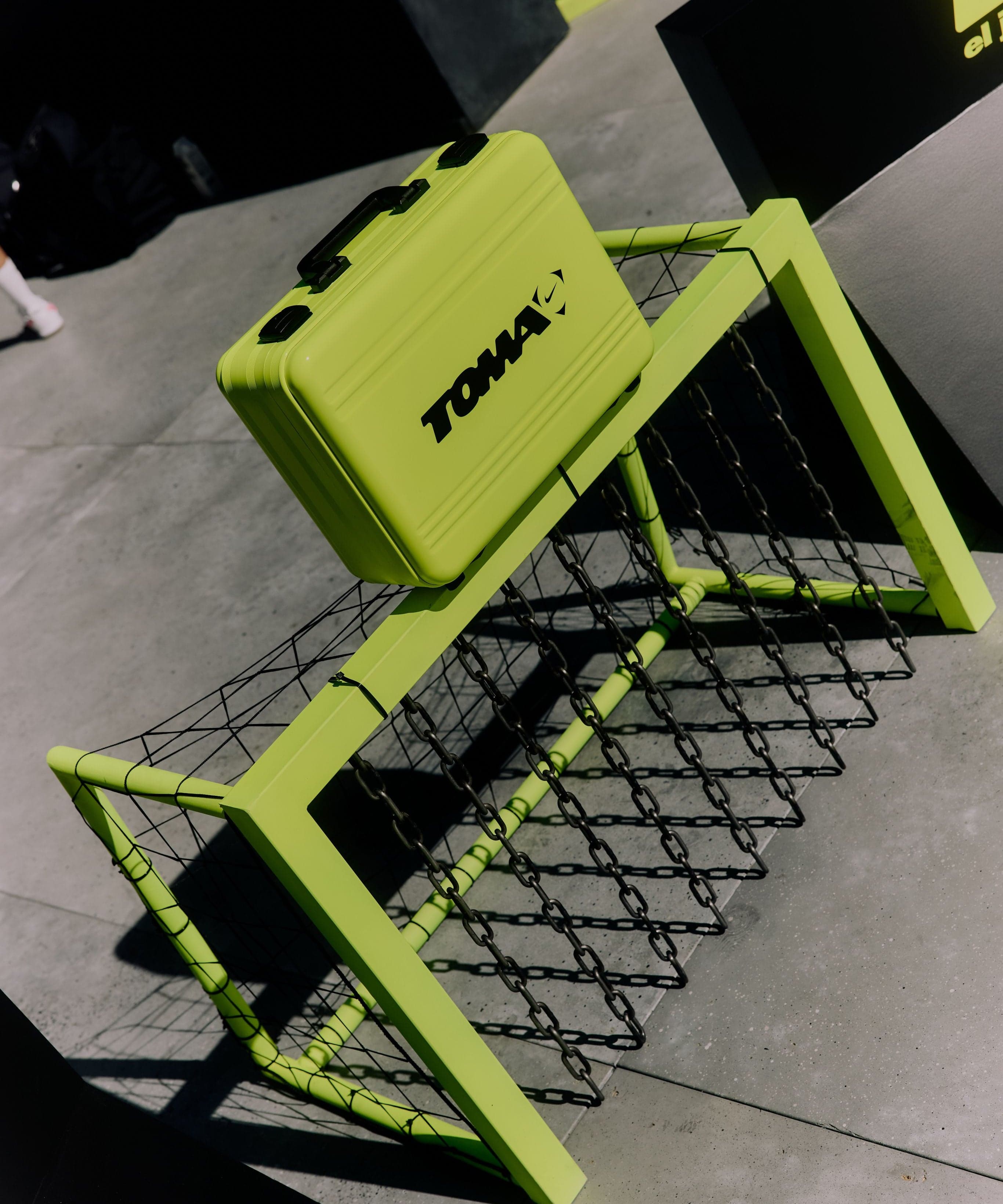 A neon-green bench shaped like a soccer goal