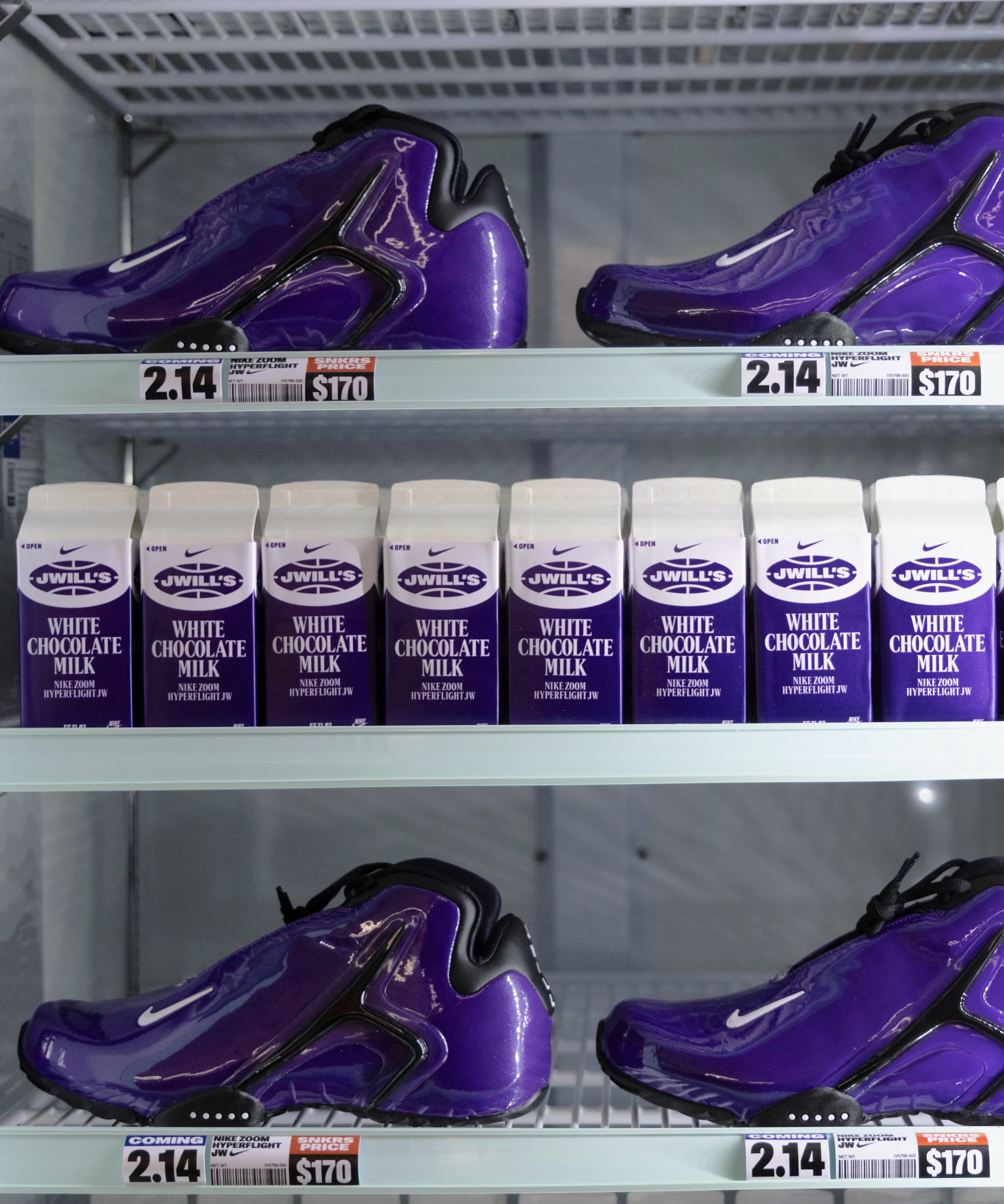 Purple sneakers on refrigerator shelves alongside cartons of chocolate milk