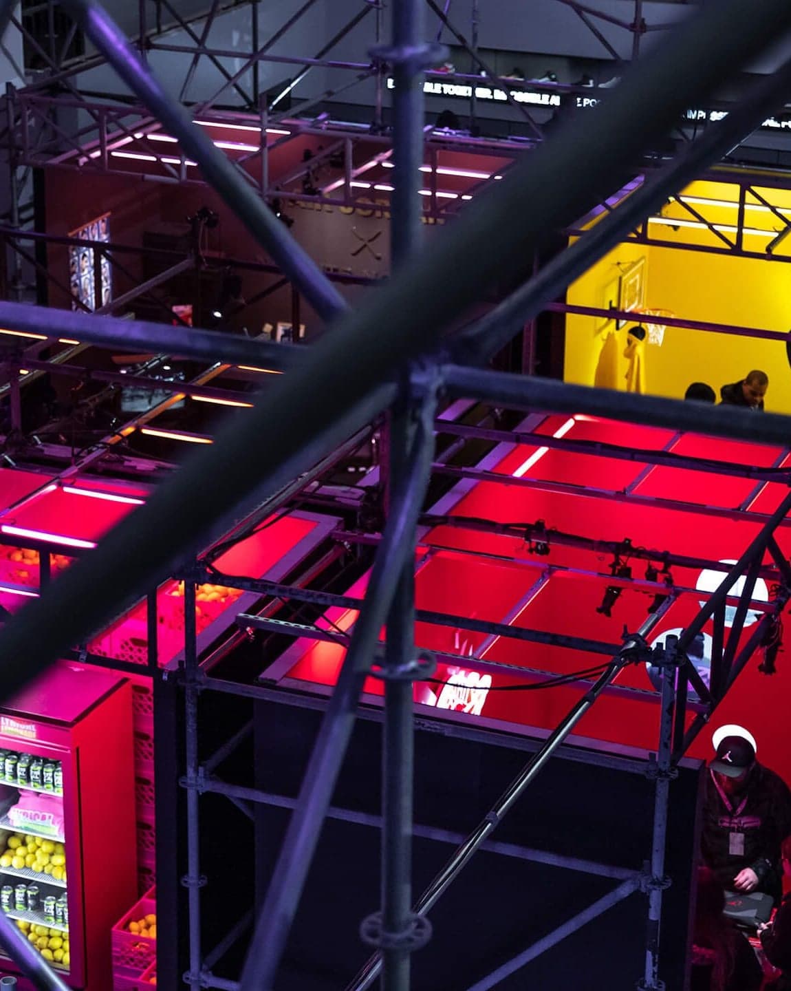 Red-lit scaffolding rooms seen from above