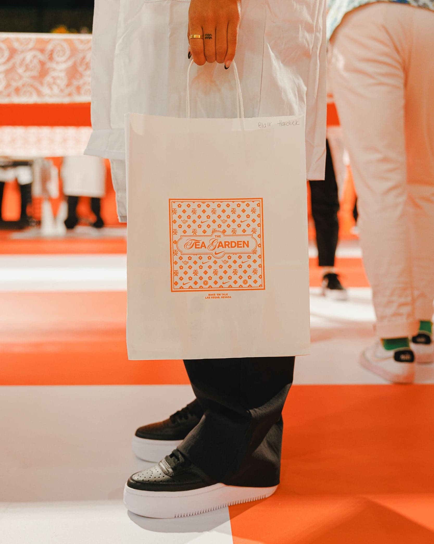 A guest carrying a Tea Garden tote bag