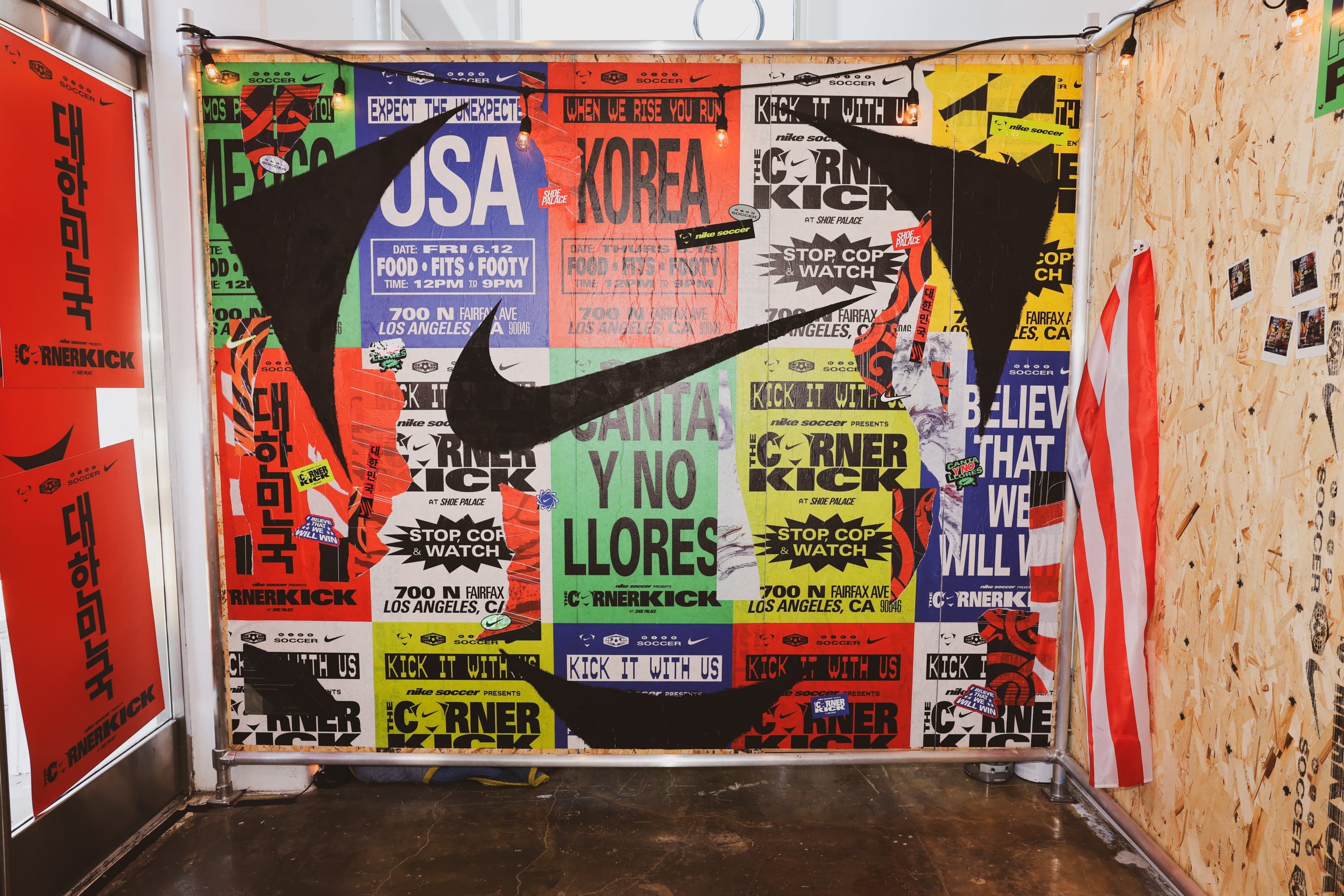 A wall of World Cup match posters with an oversized Nike swoosh