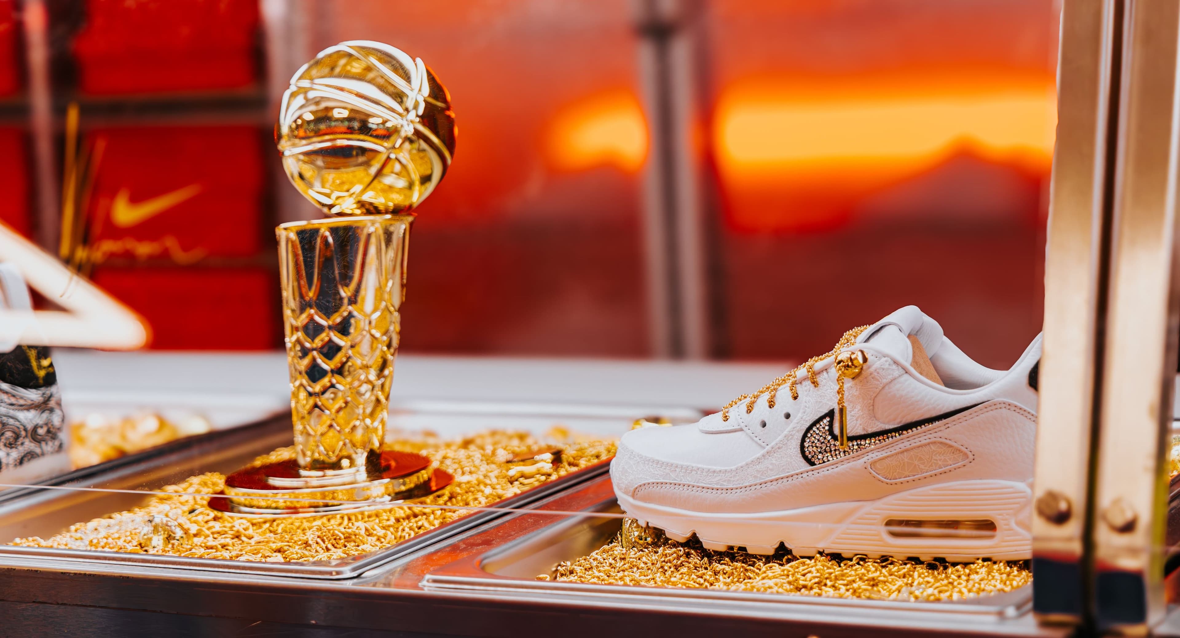 A gold trophy and a white Nike sneaker served on a bed of gold at the cafeteria counter
