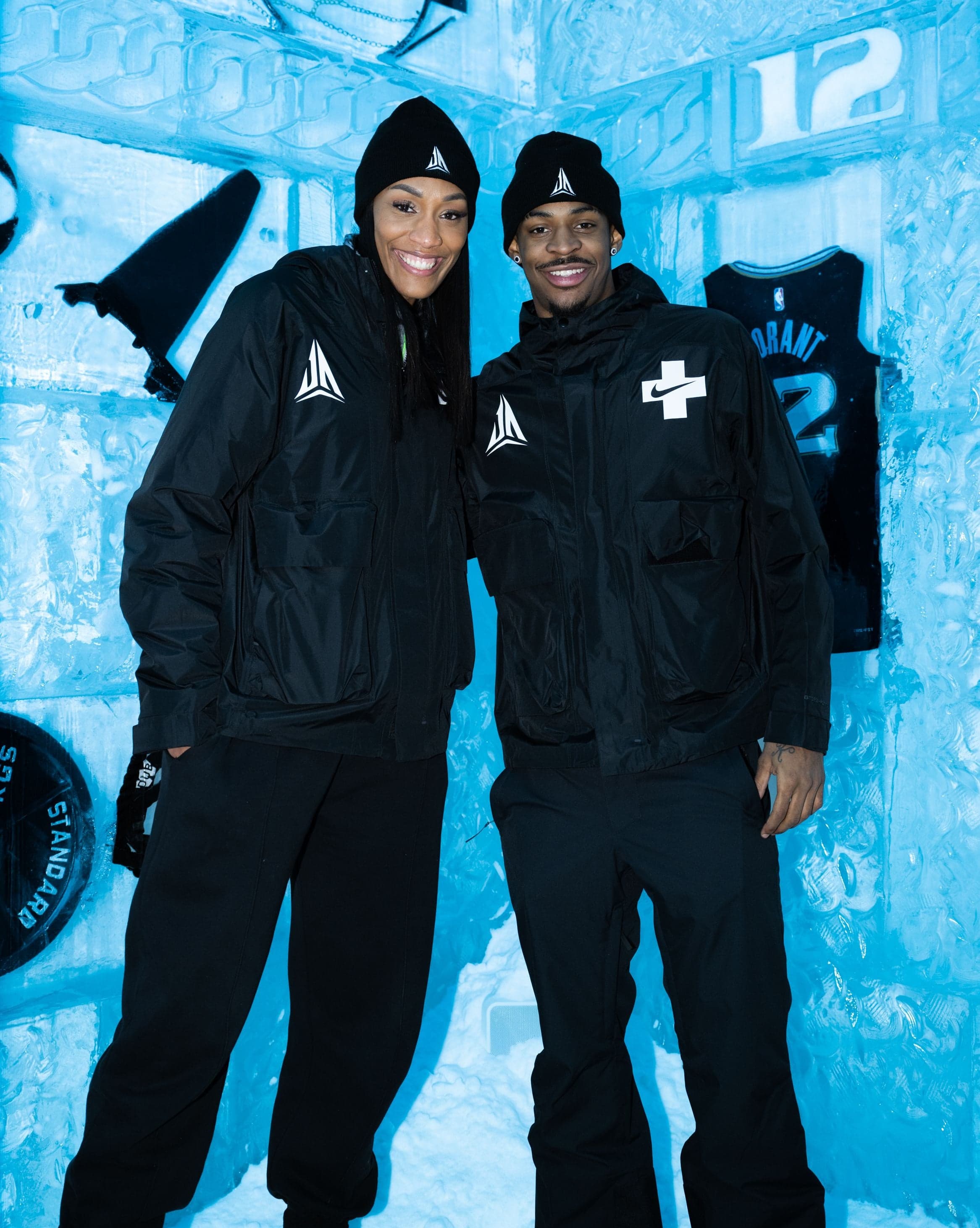 Two staff in black jackets posing inside the ice room