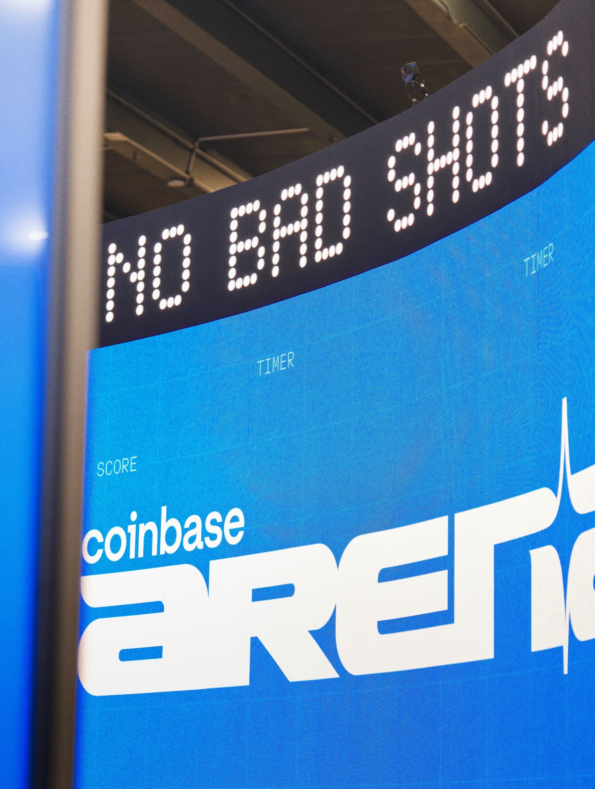 “No Bad Shots” scrolling on the LED ticker above a Coinbase Arena wall