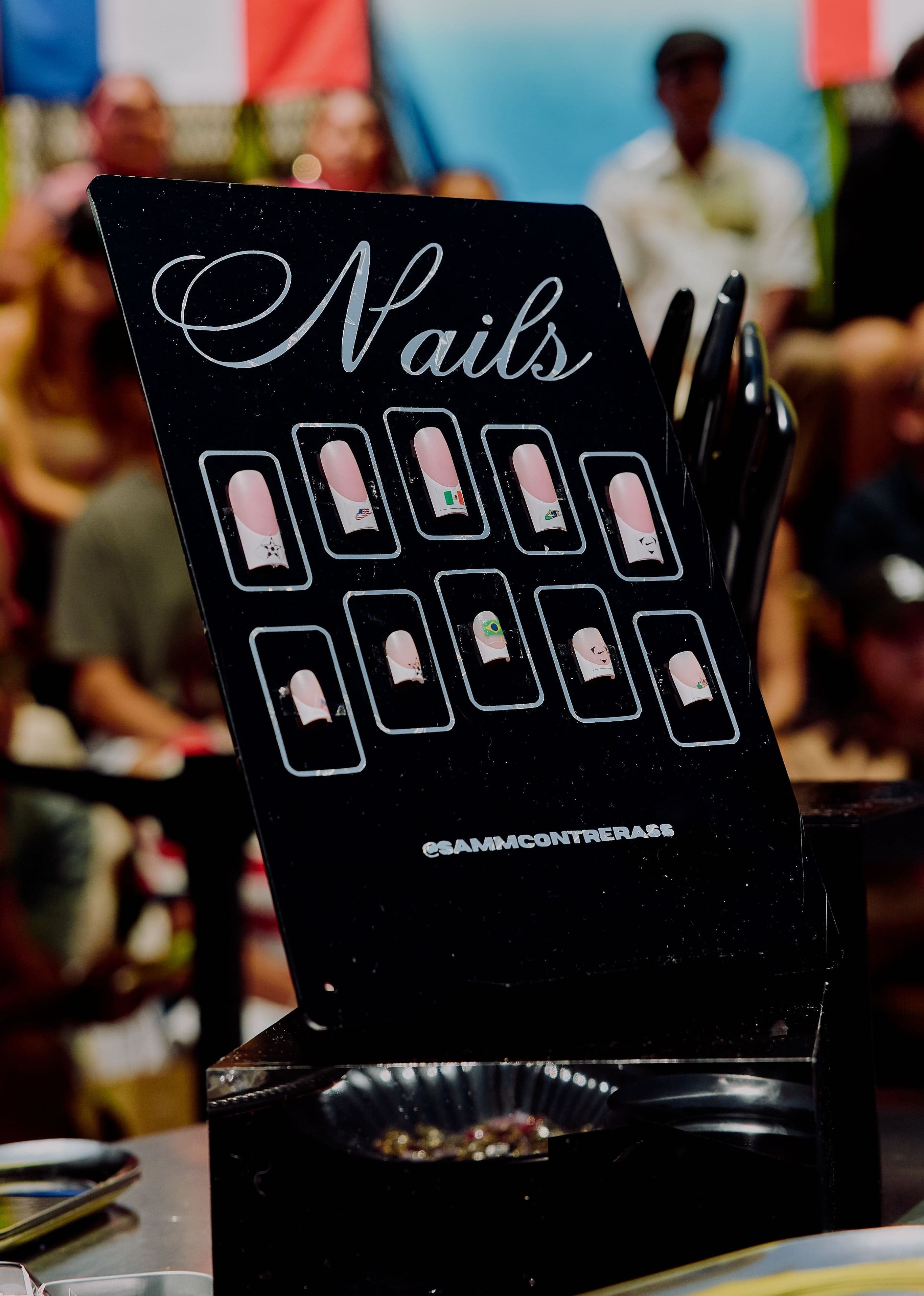 A Nails sign showing nail designs at the customization station