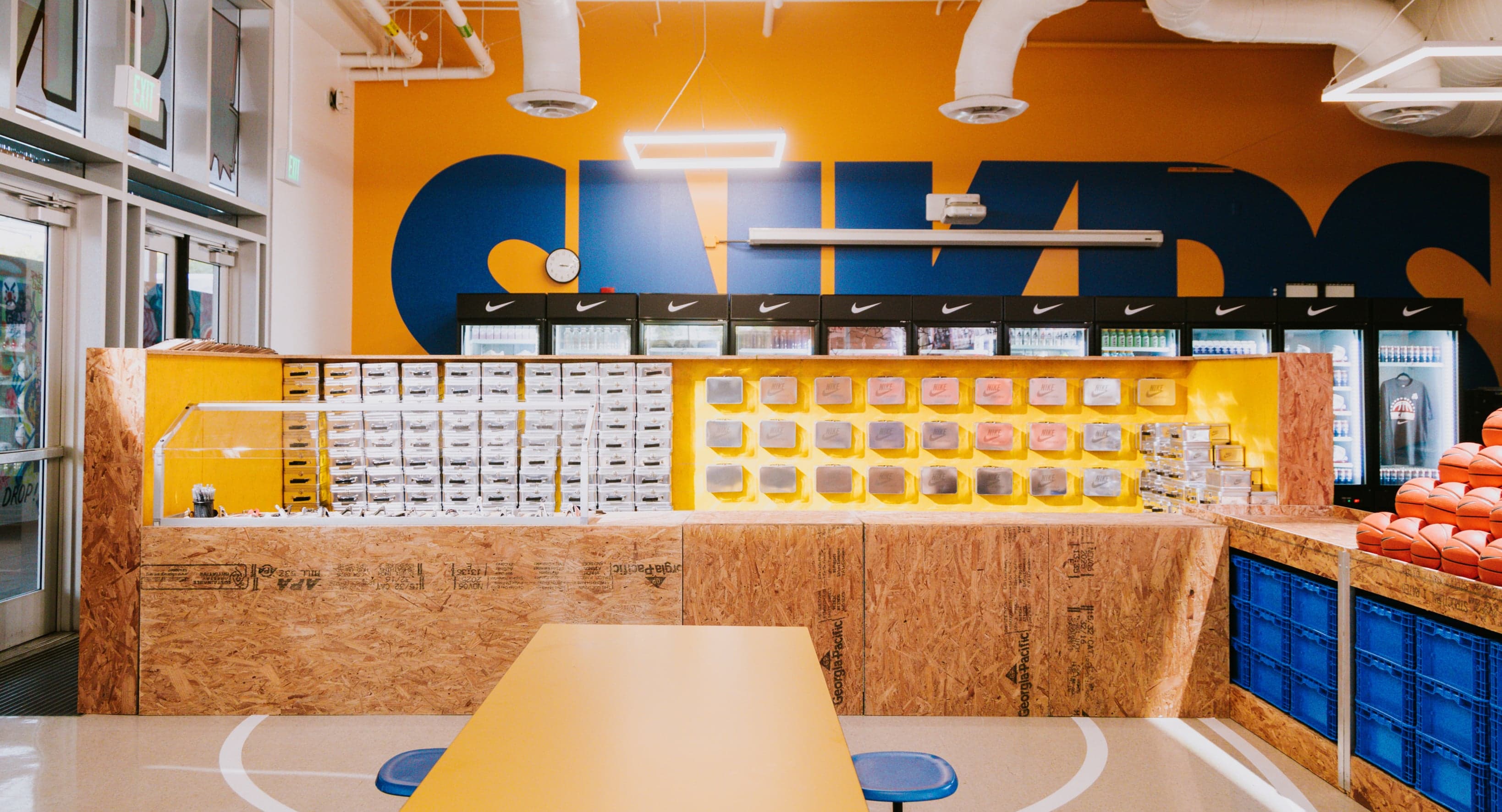 The SNKRS Cafeteria counter and seating under a painted SNKRS mural
