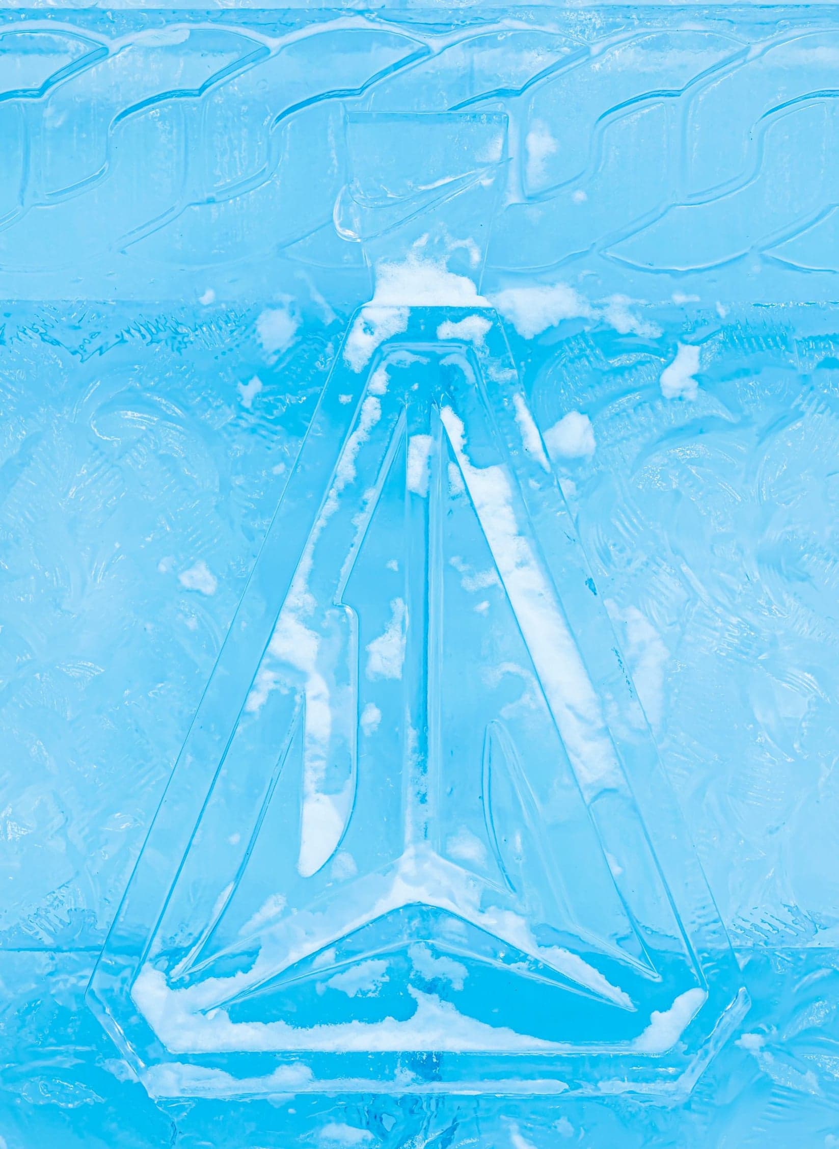 The Ja logo and a basketball hoop frozen in an ice wall