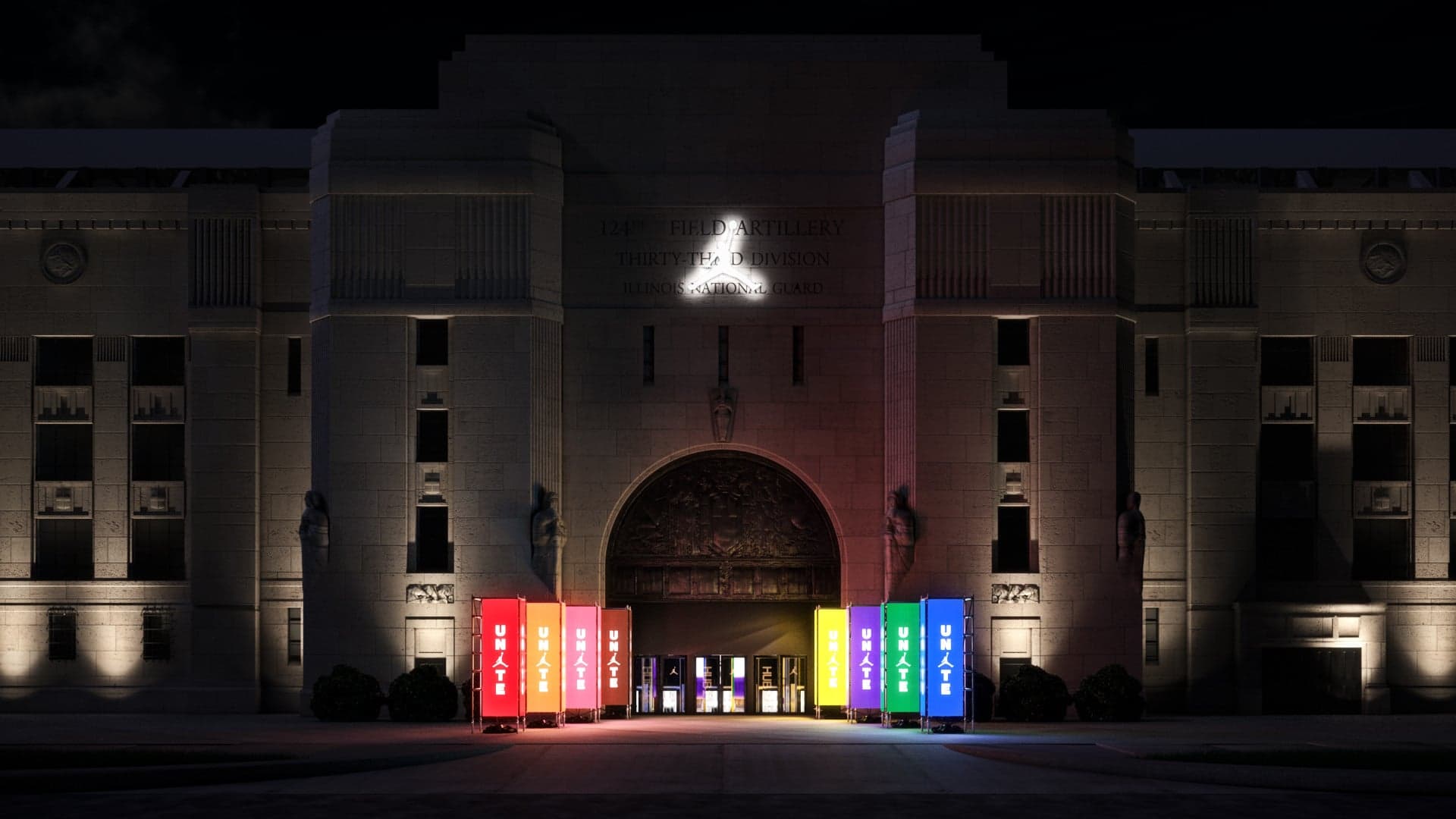 The Jordan Jumpman lit above the arched entrance of the building at night, with colourful banners at the doors