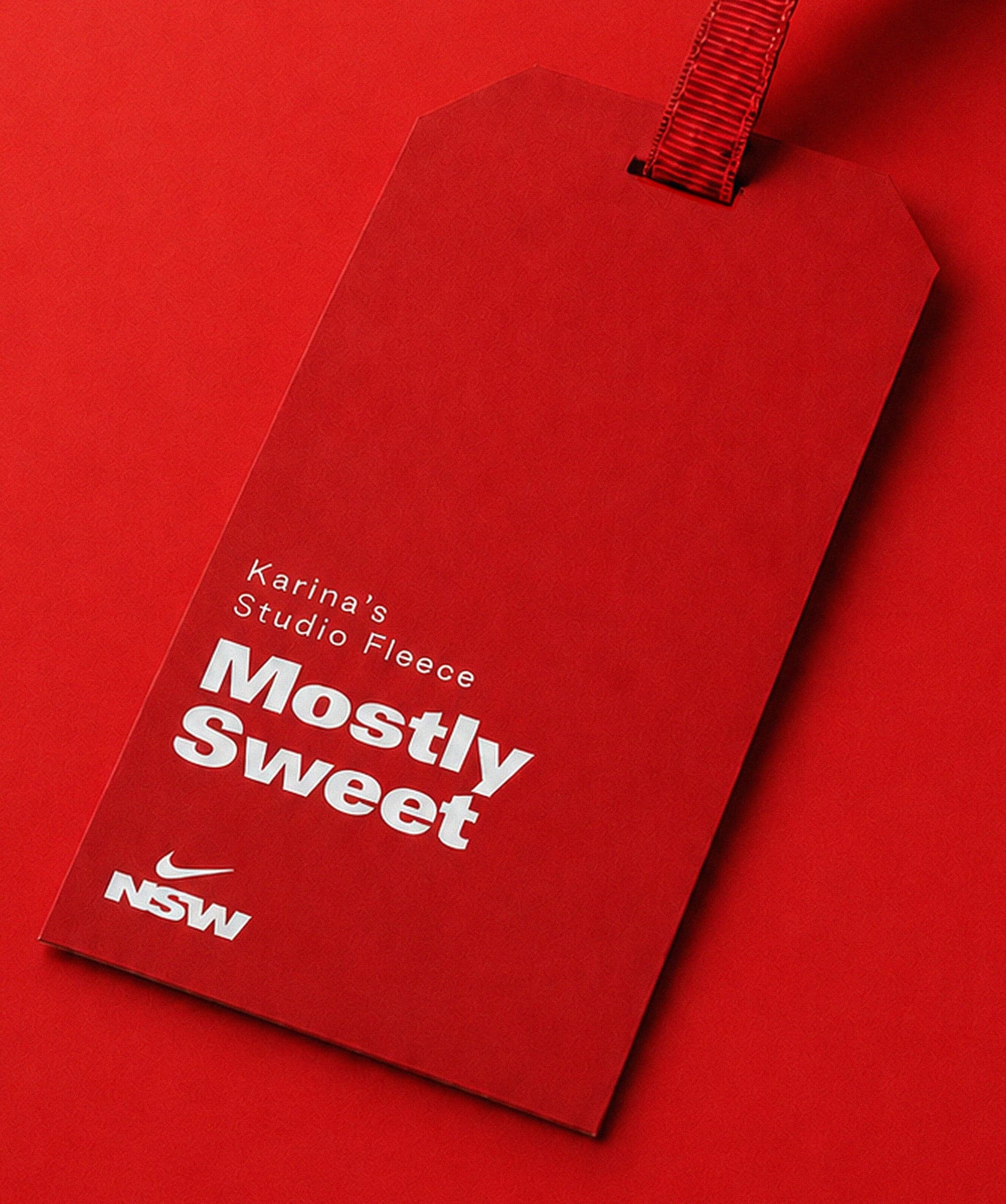 A red “Mostly Sweet” hang tag on a red background