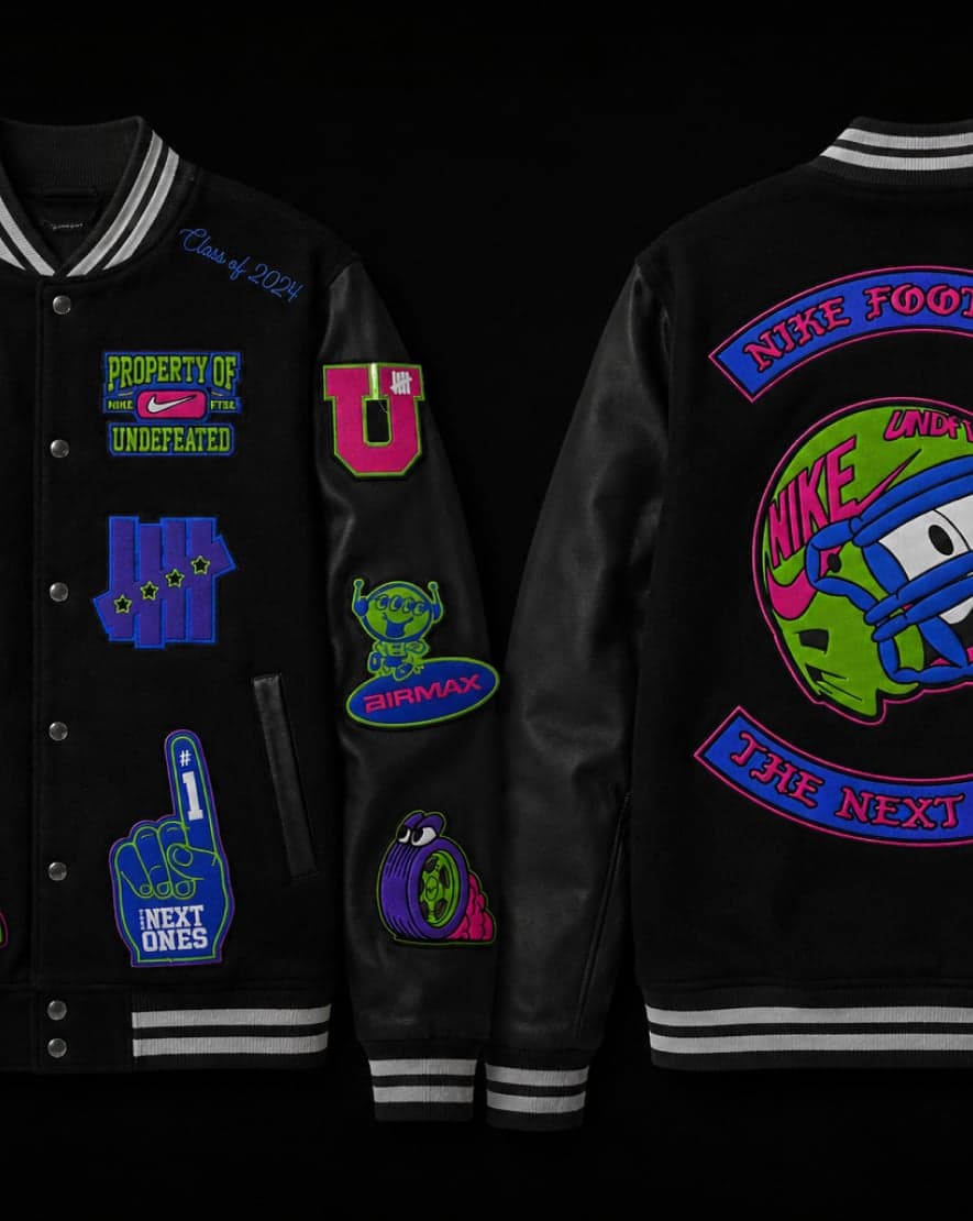 Front and back of the black Nike Football varsity jacket covered in patches