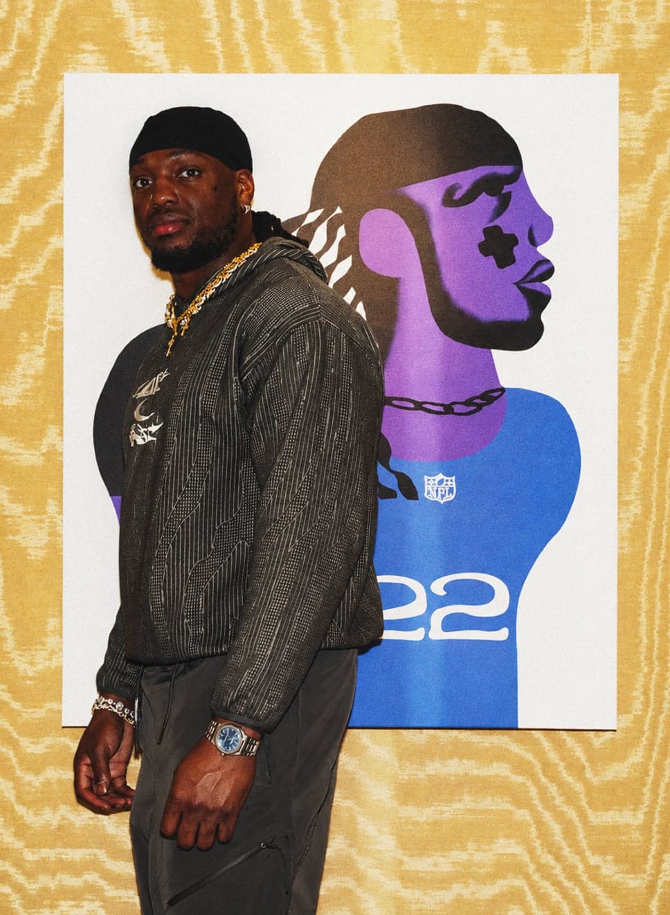 A player posing beside their illustrated portrait