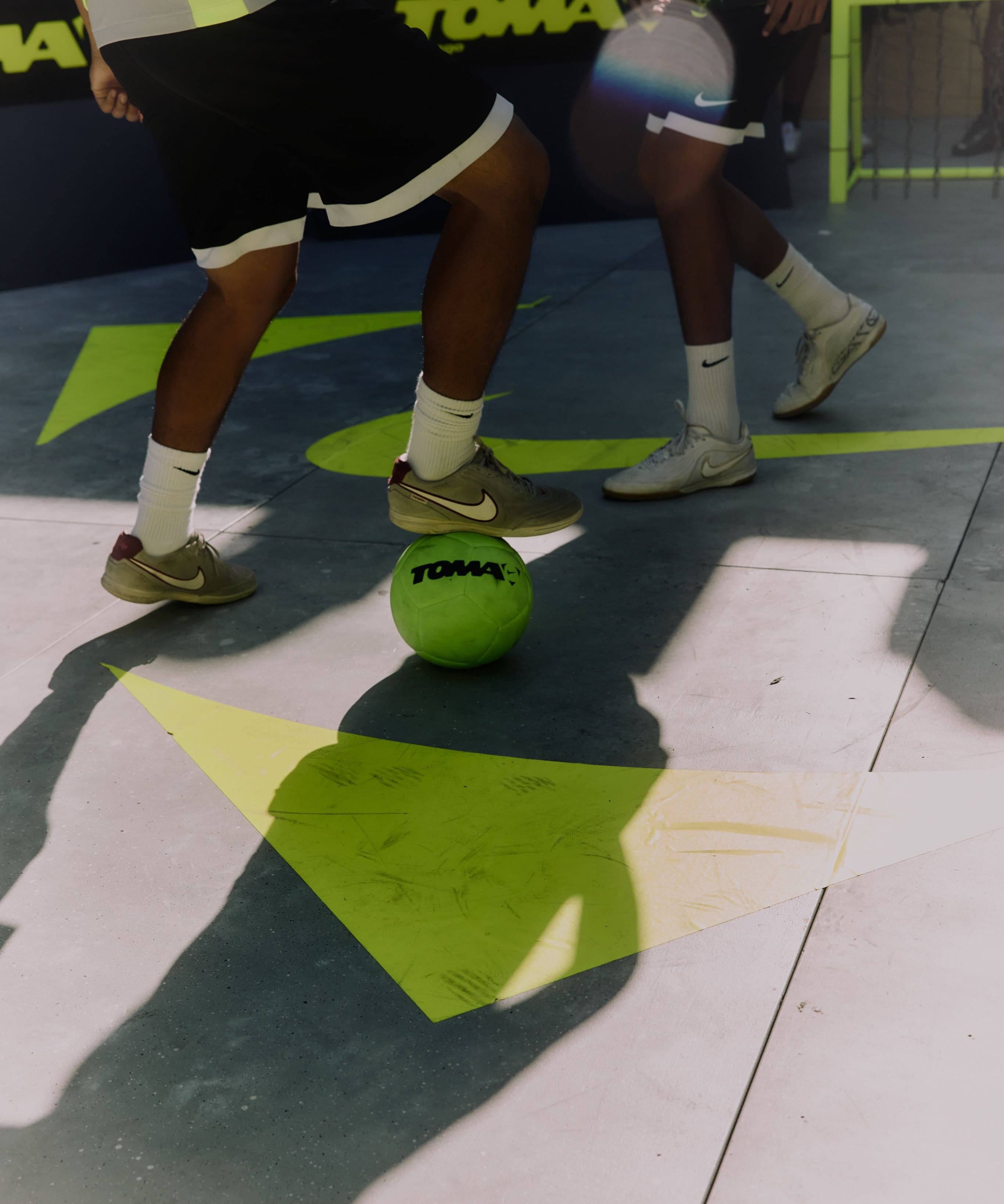 Players dribbling a ball across the pitch