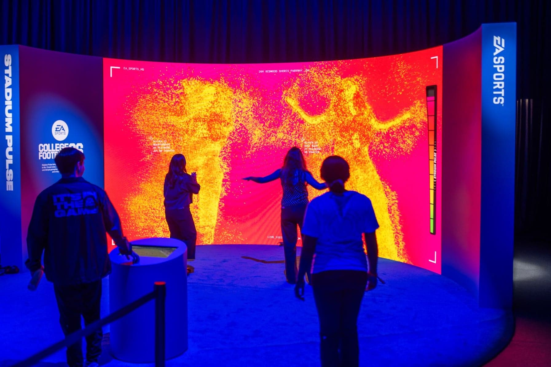Guests in front of the Stadium Pulse screen as their movements light up a red and yellow heat map