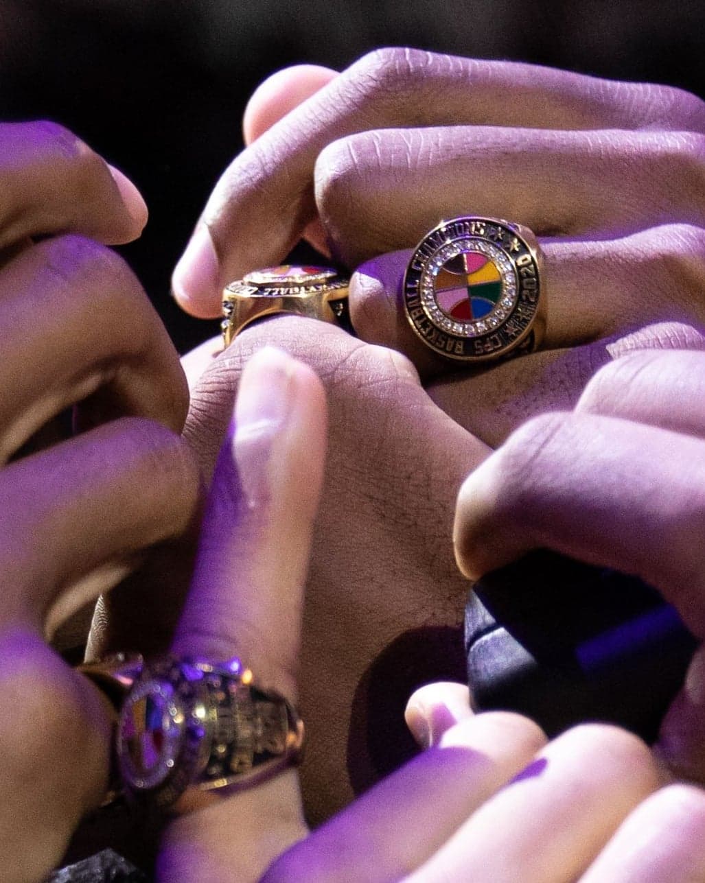 Hands wearing championship rings