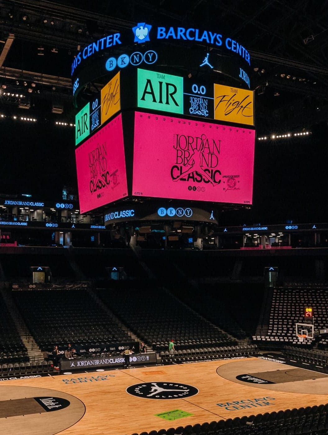 The Barclays Center scoreboard lit pink and green with Jordan Brand Classic graphics above the empty court