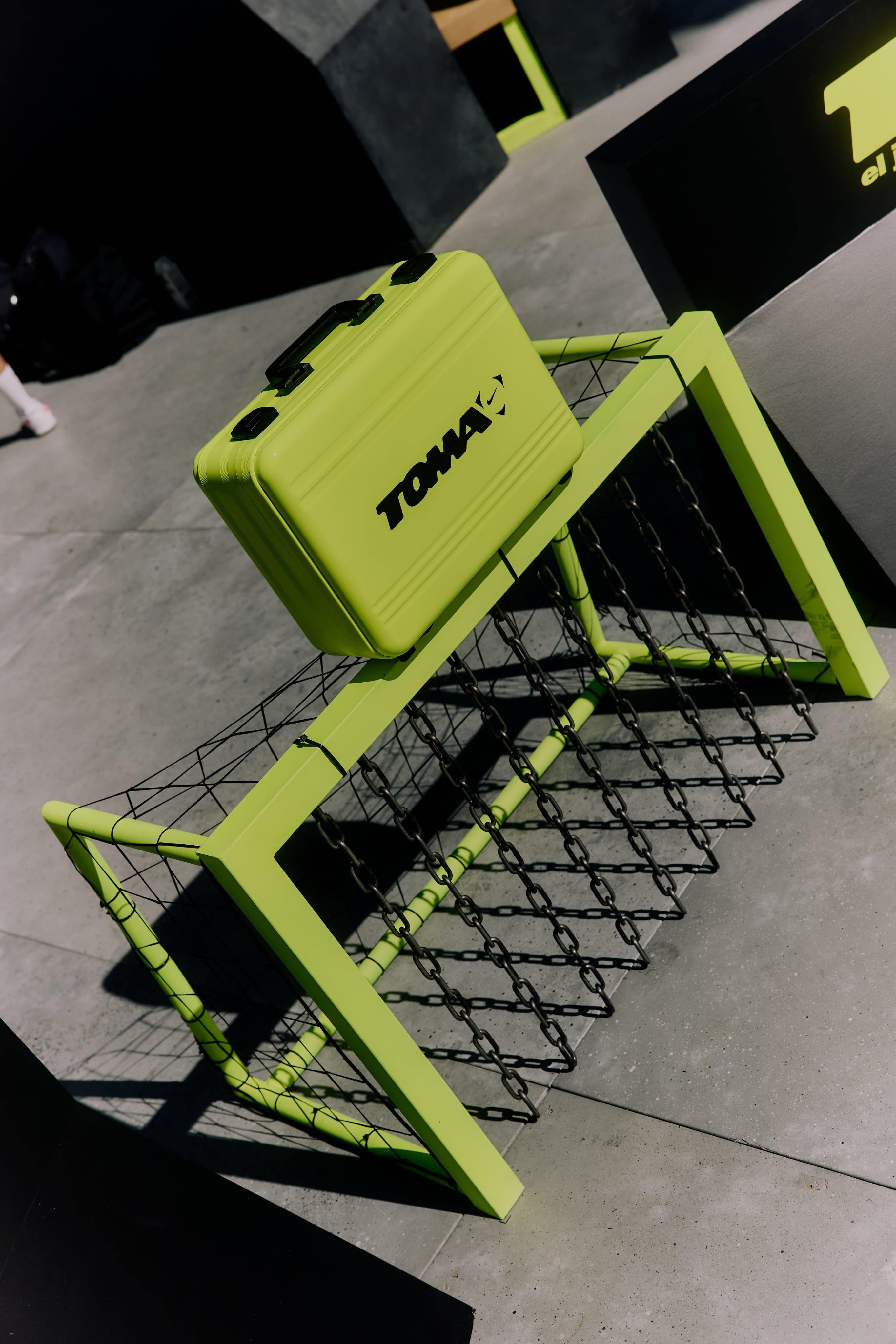 A neon-green bench shaped like a soccer goal