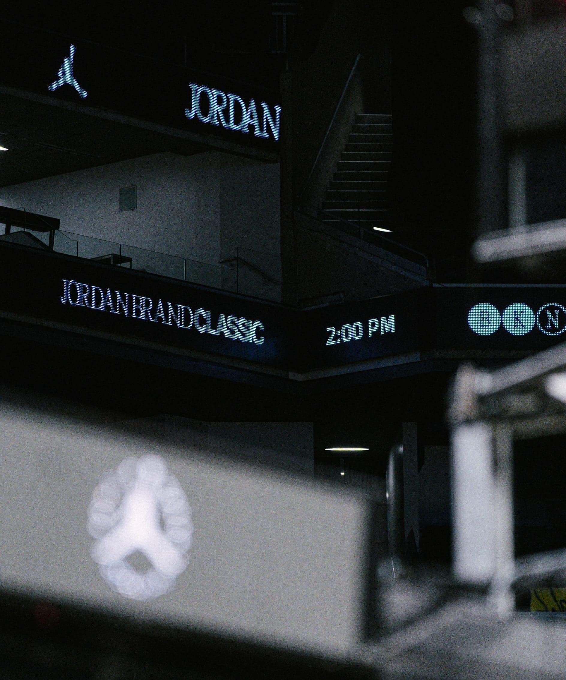 Arena LED boards reading Jordan Brand Classic and 2:00 PM above a lit Jumpman screen