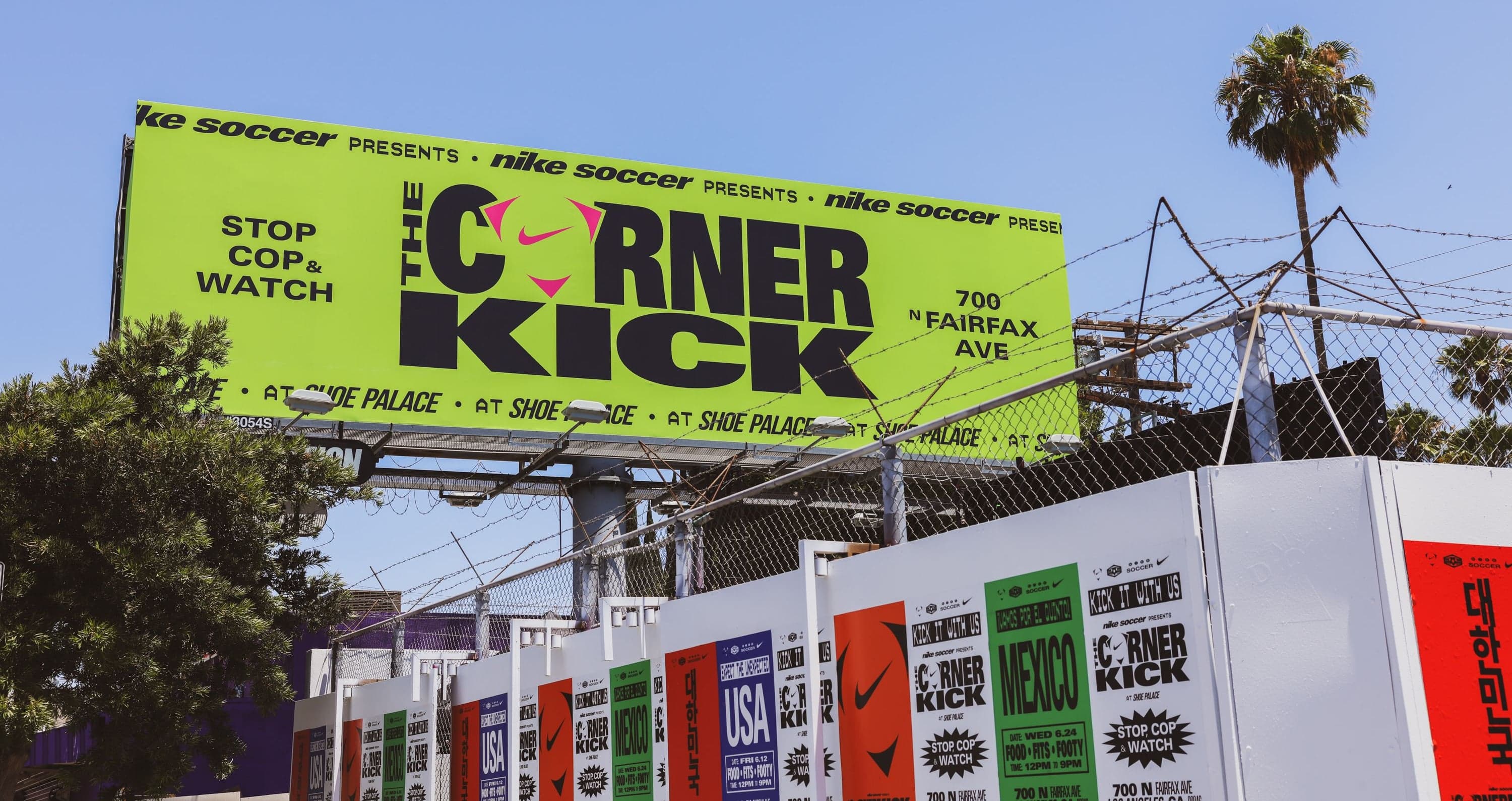 The Corner Kick billboard above the building, with palm trees behind