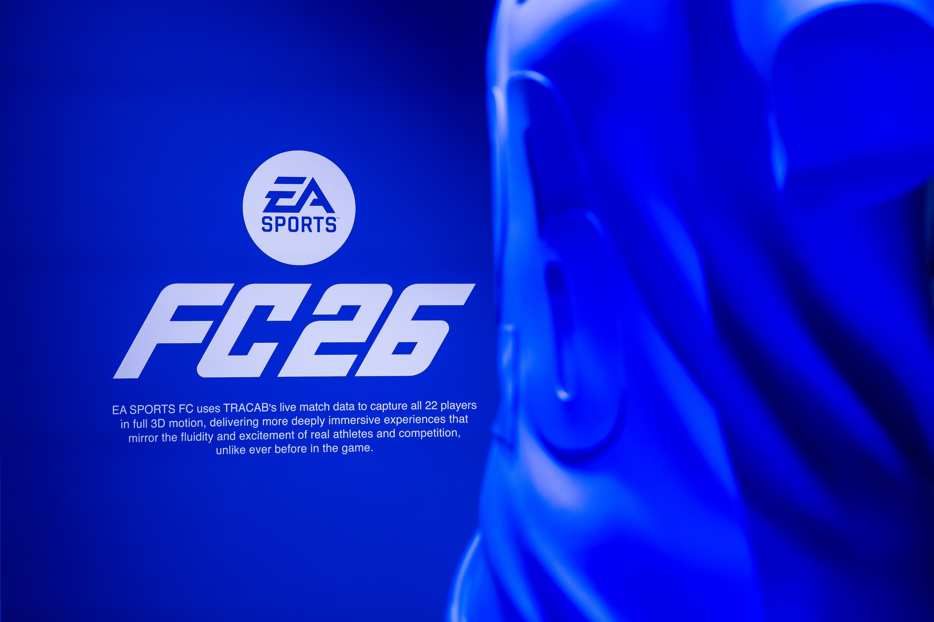 An EA Sports FC 26 graphic about TRACAB live match data beside a close-up of a blue 3D jersey