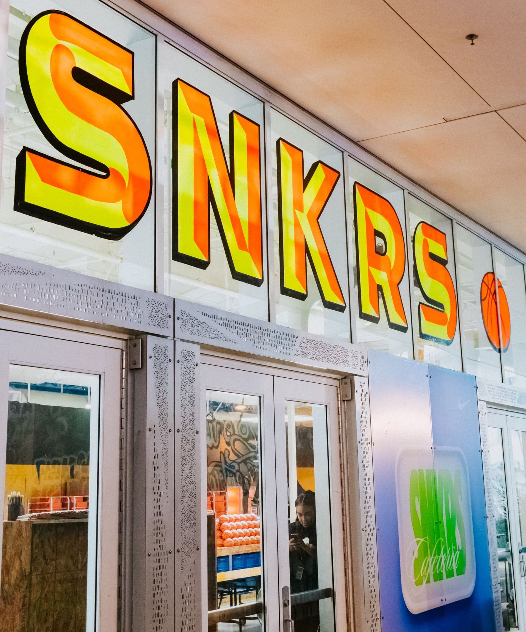 The SNKRS Cafeteria entrance with a hand-painted “Hourly Drops” sign