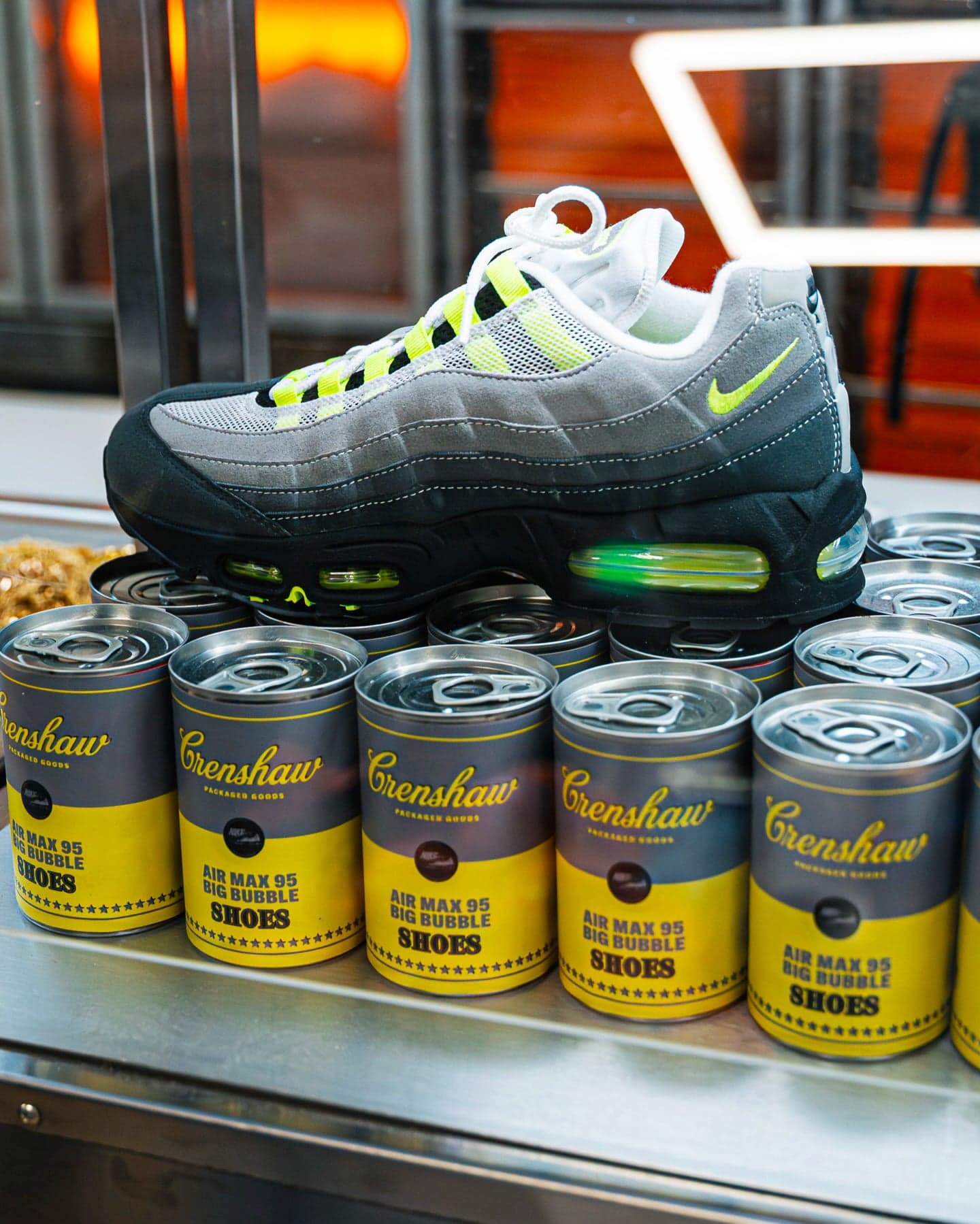 A Nike Air Max sneaker on top of a stack of branded food cans