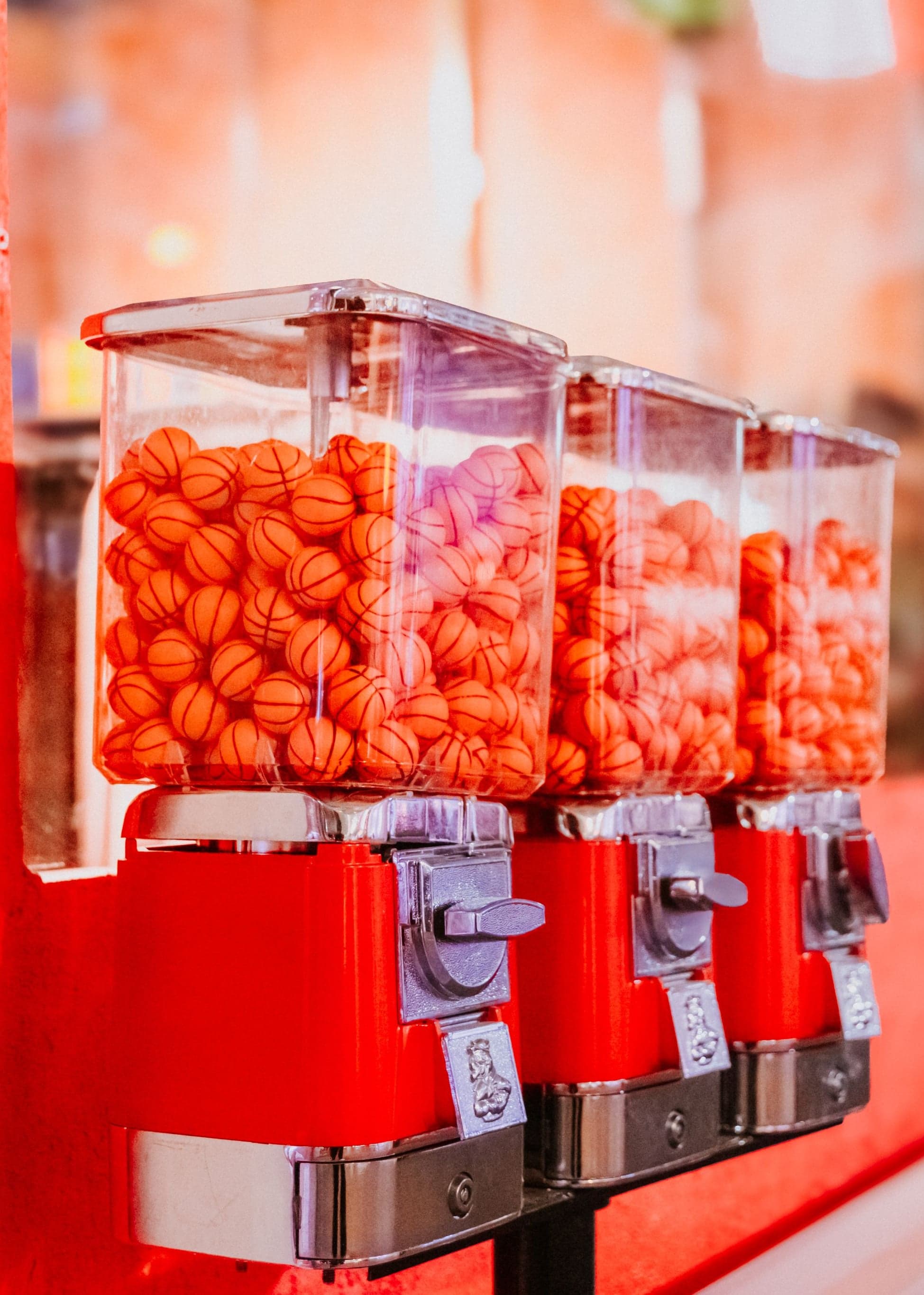 Gumball machines filled with orange basketball gumballs