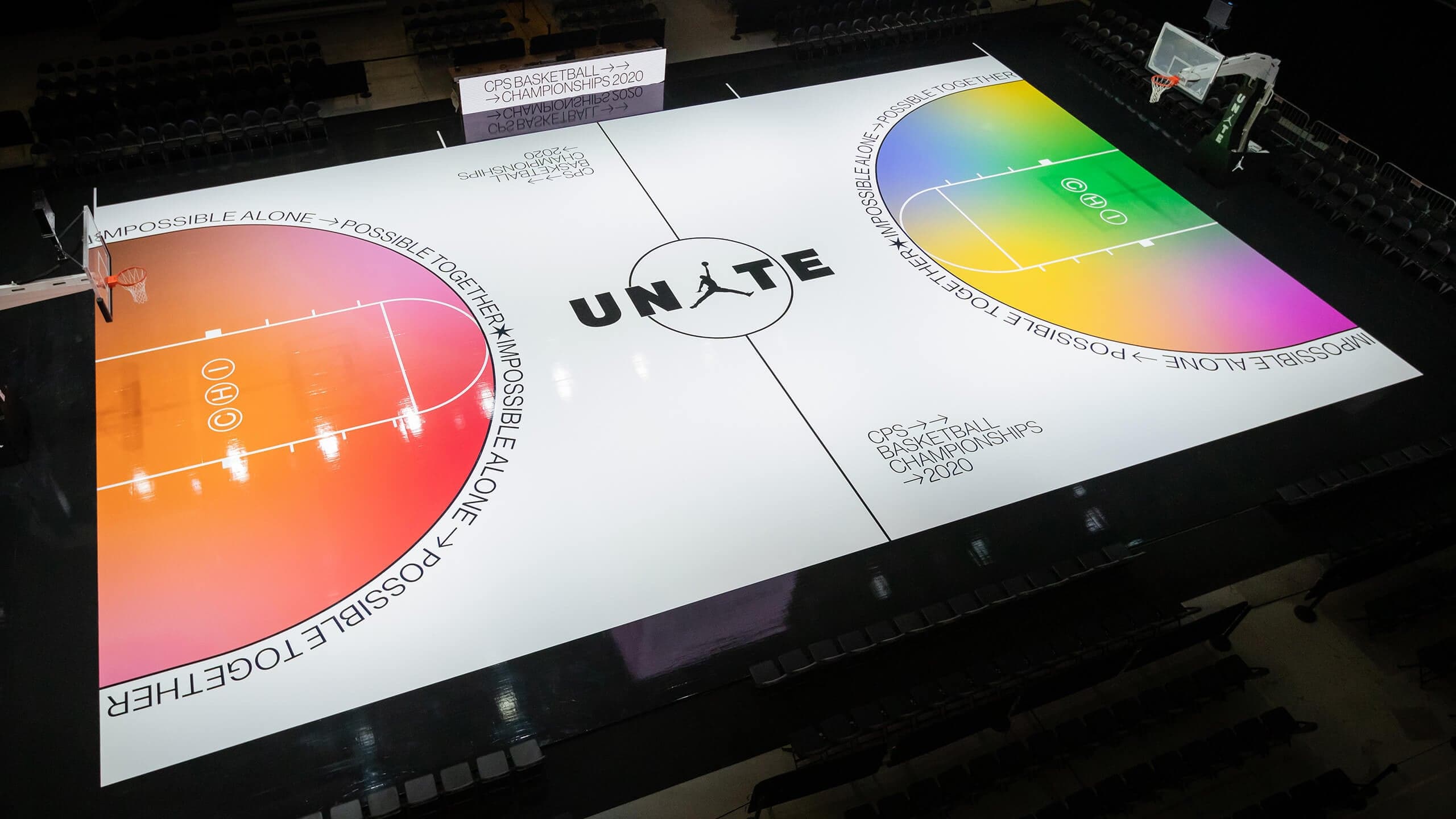 A white court with the UNITE logo and orange and rainbow gradient keys, seen from above