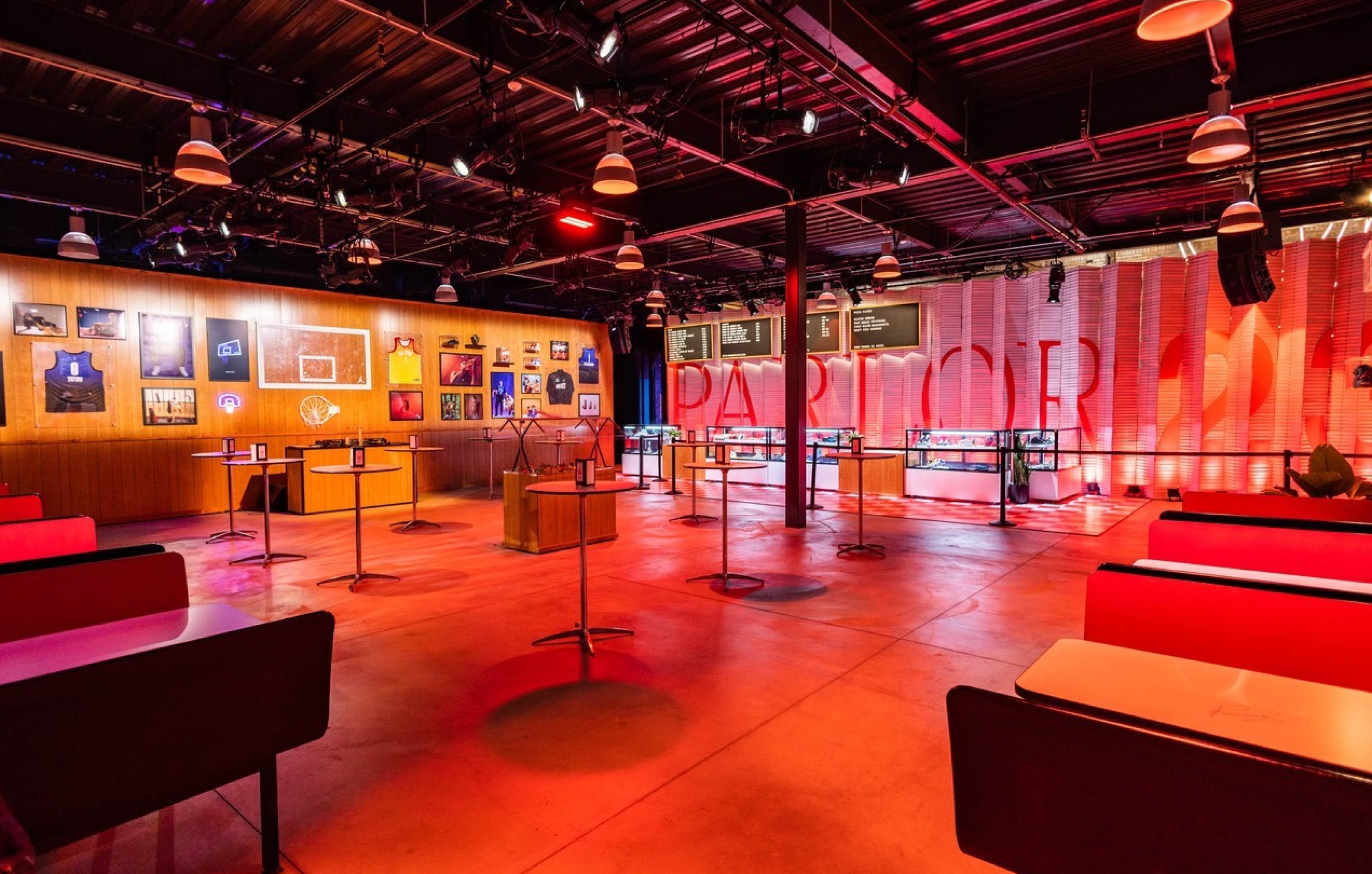The red-lit dining room with booths, framed jerseys and the Parlor 23 wall