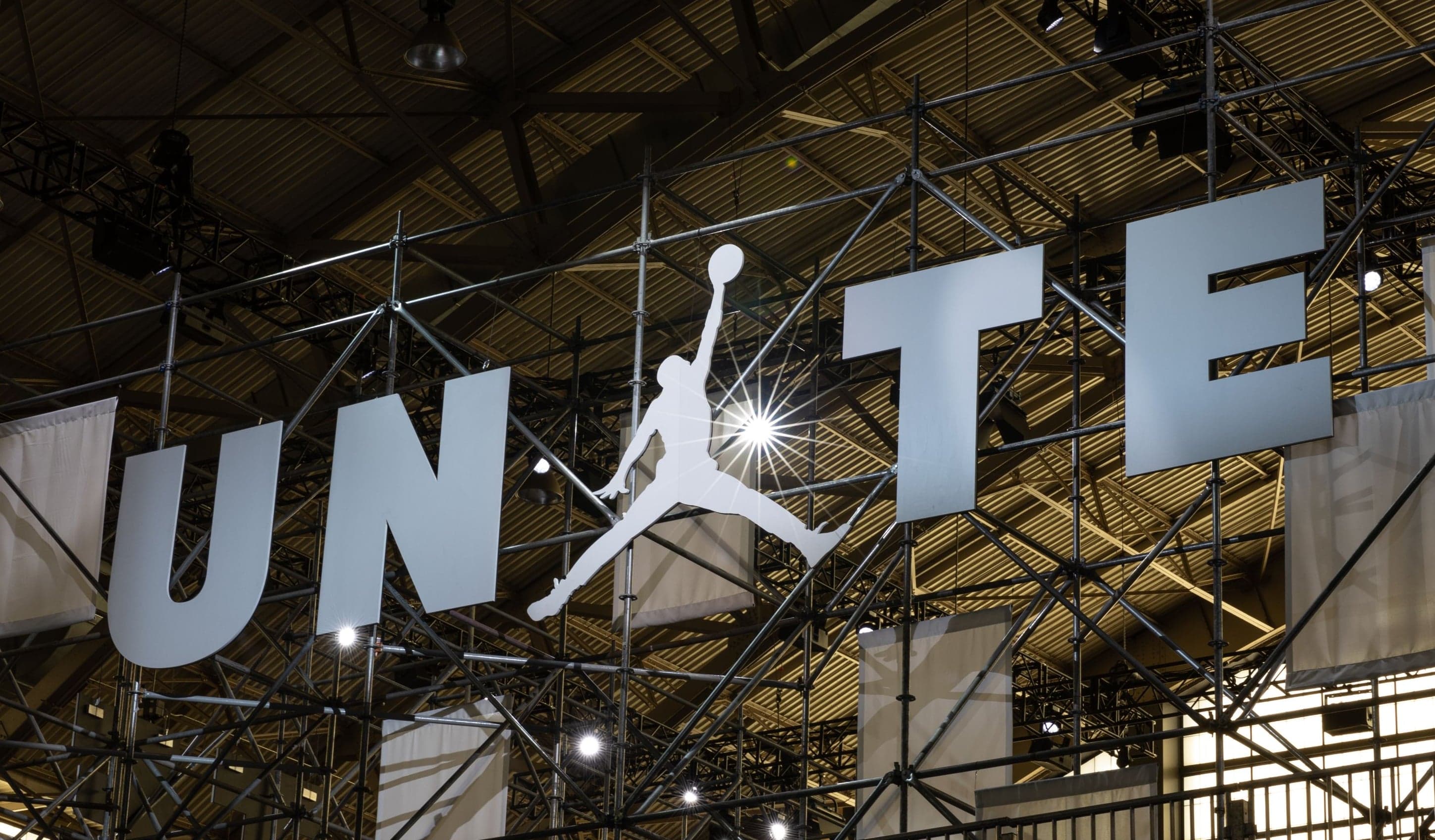 The UNITE sign with the Jumpman, hanging in the rafters