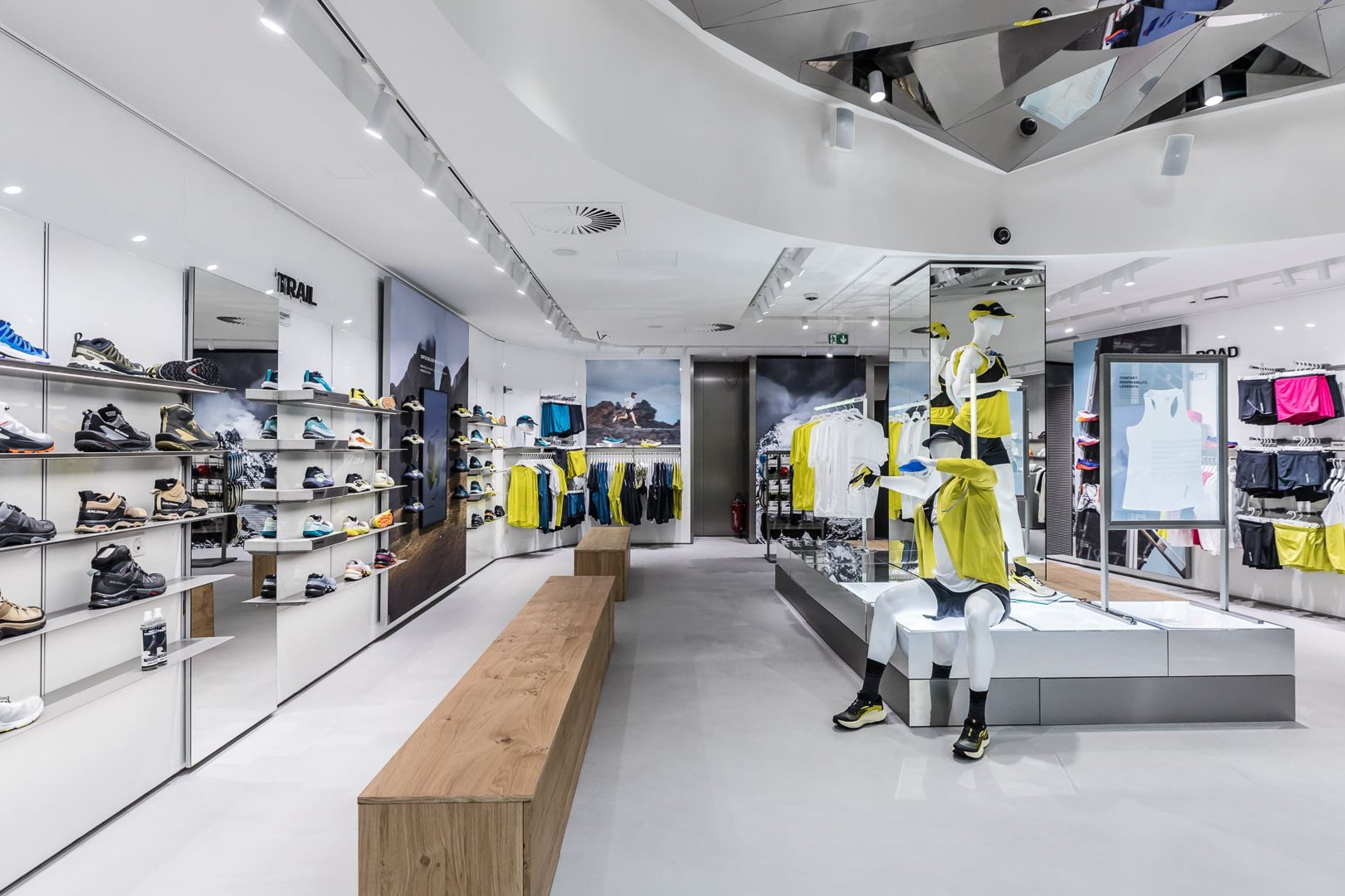 A footwear wall and apparel floor with a long wooden bench
