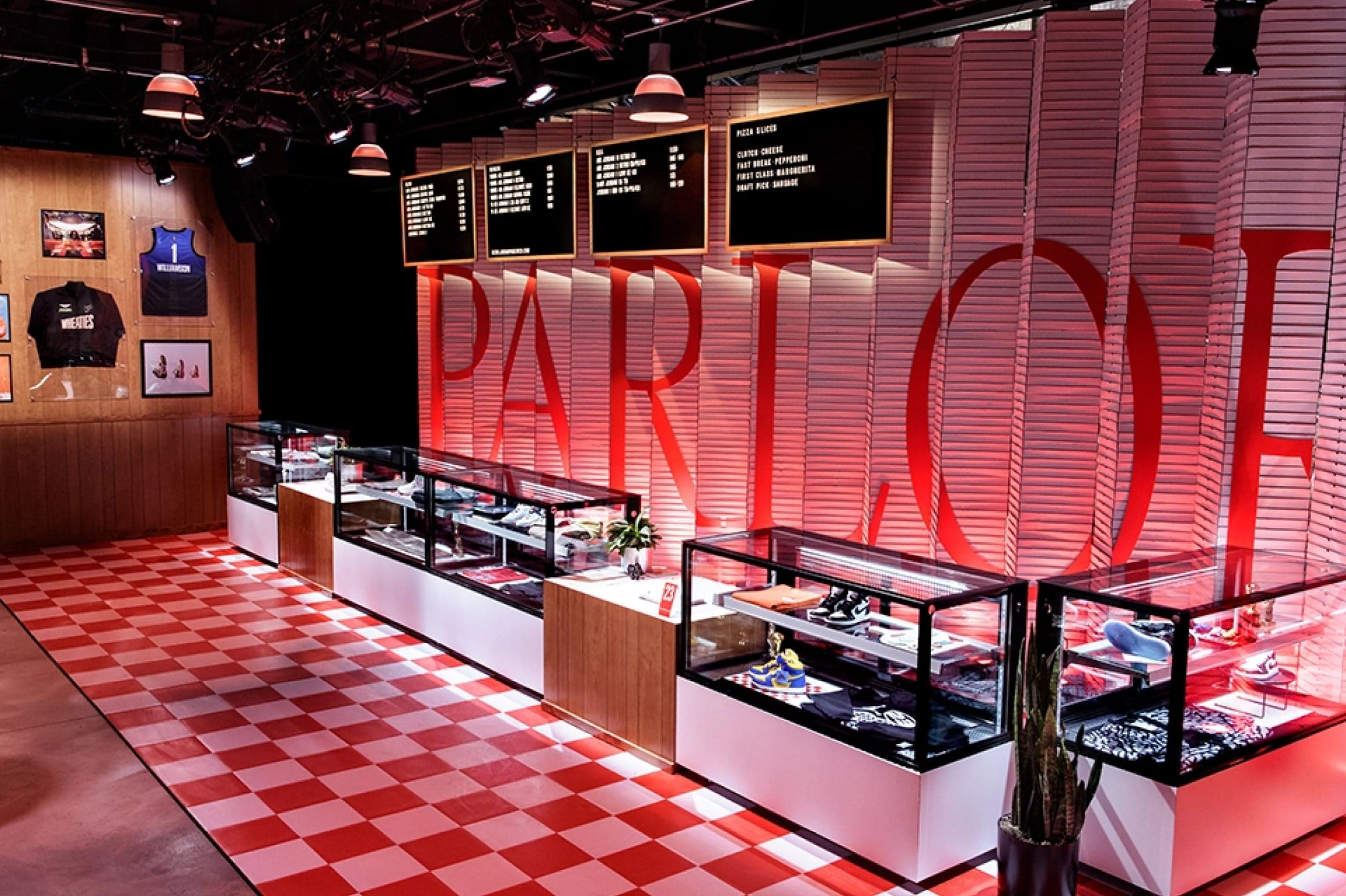 The Parlor 23 shop, glass display counters on a red-and-white checkered floor beneath a large red sign
