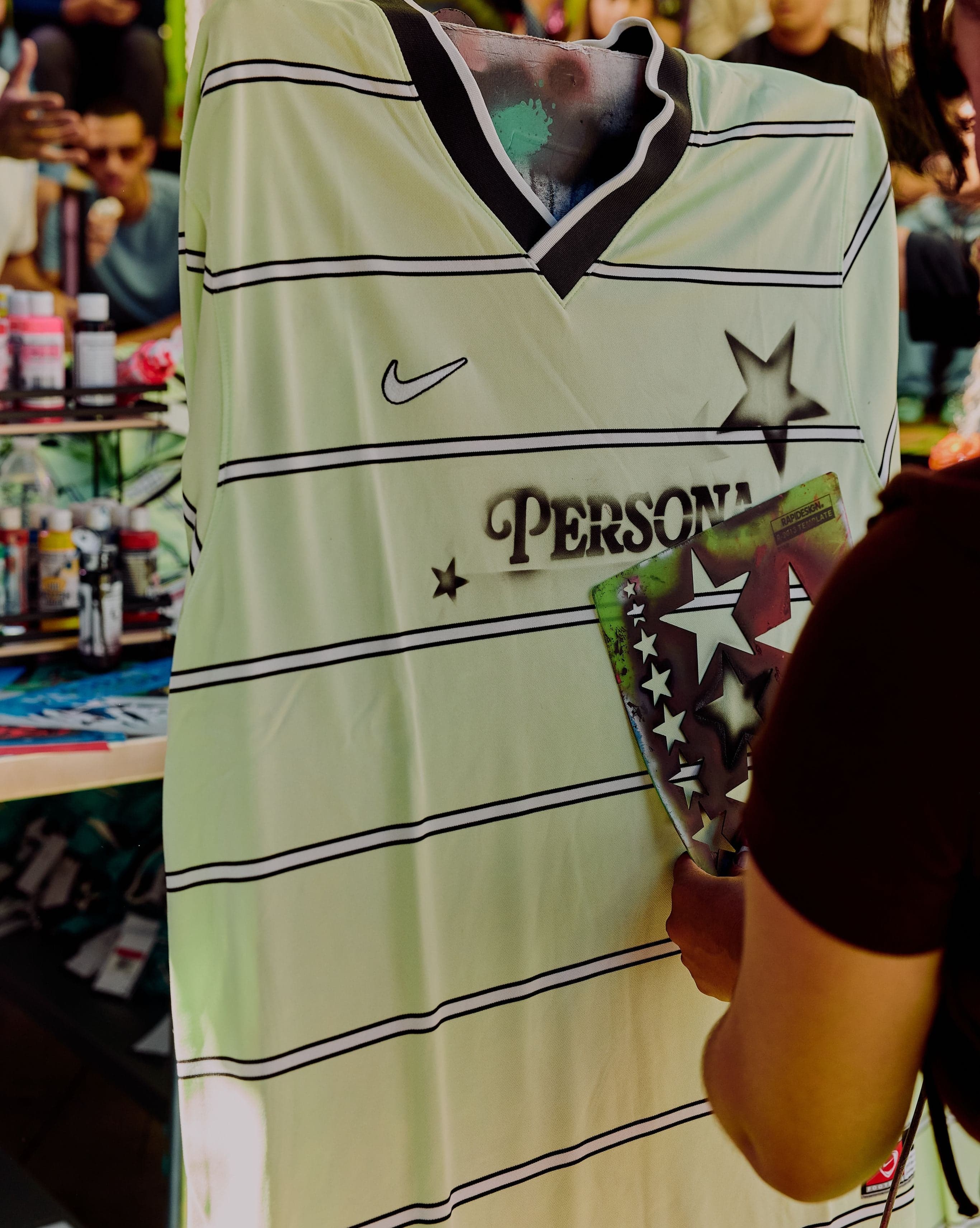 A guest customizing a striped Persona jersey