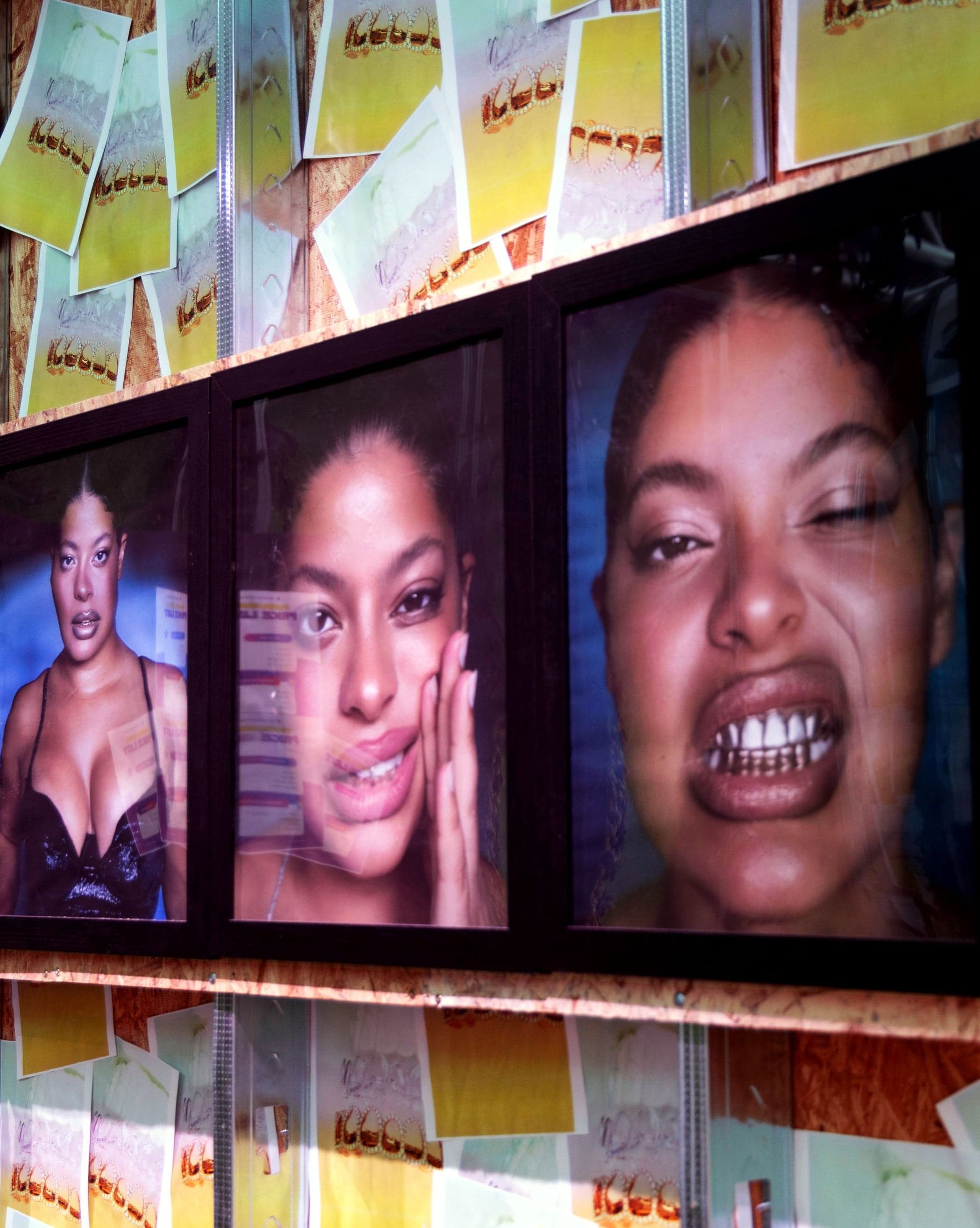 A row of screens showing close-up portraits