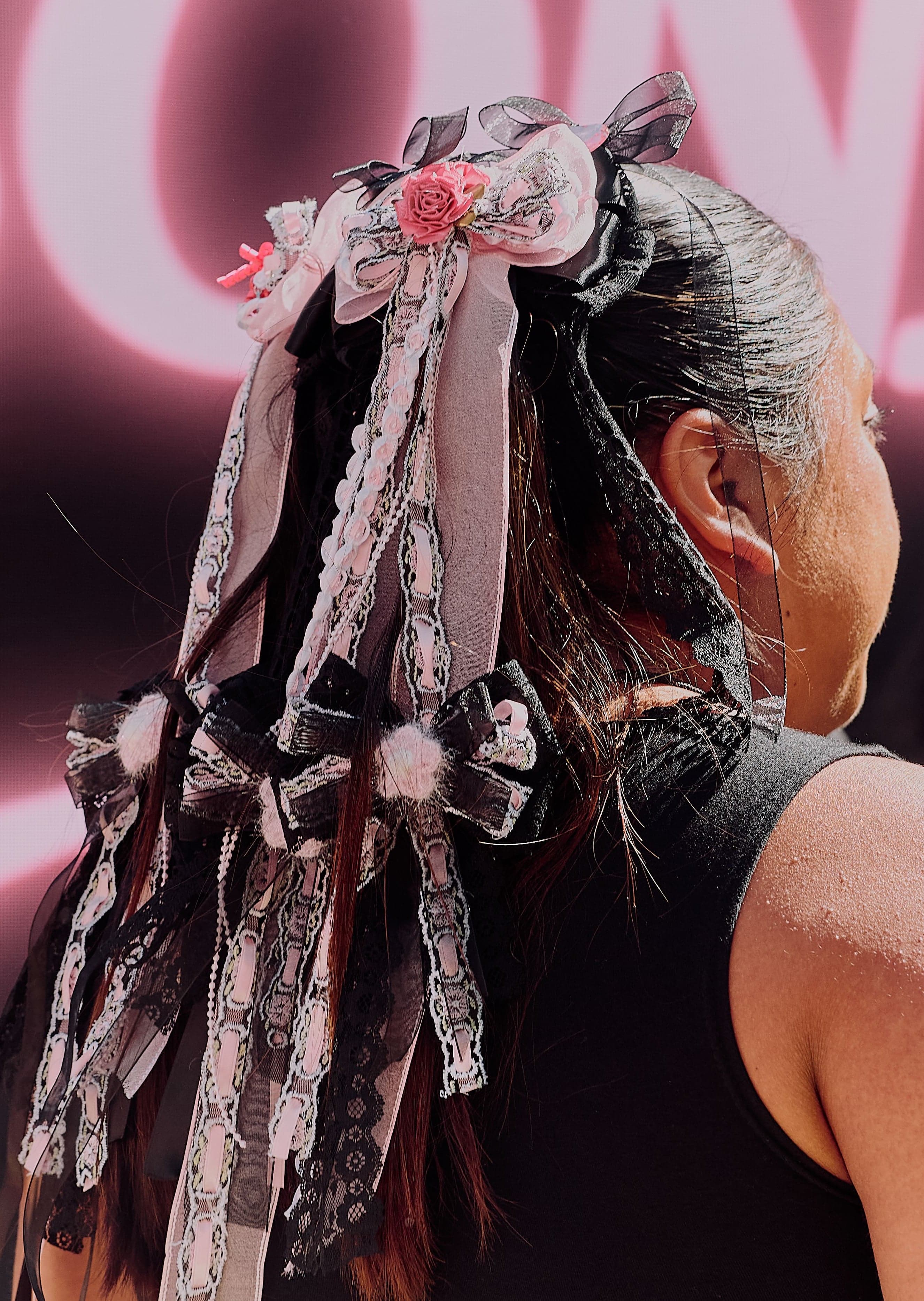 Ribbons and charms tied into a guest’s hair